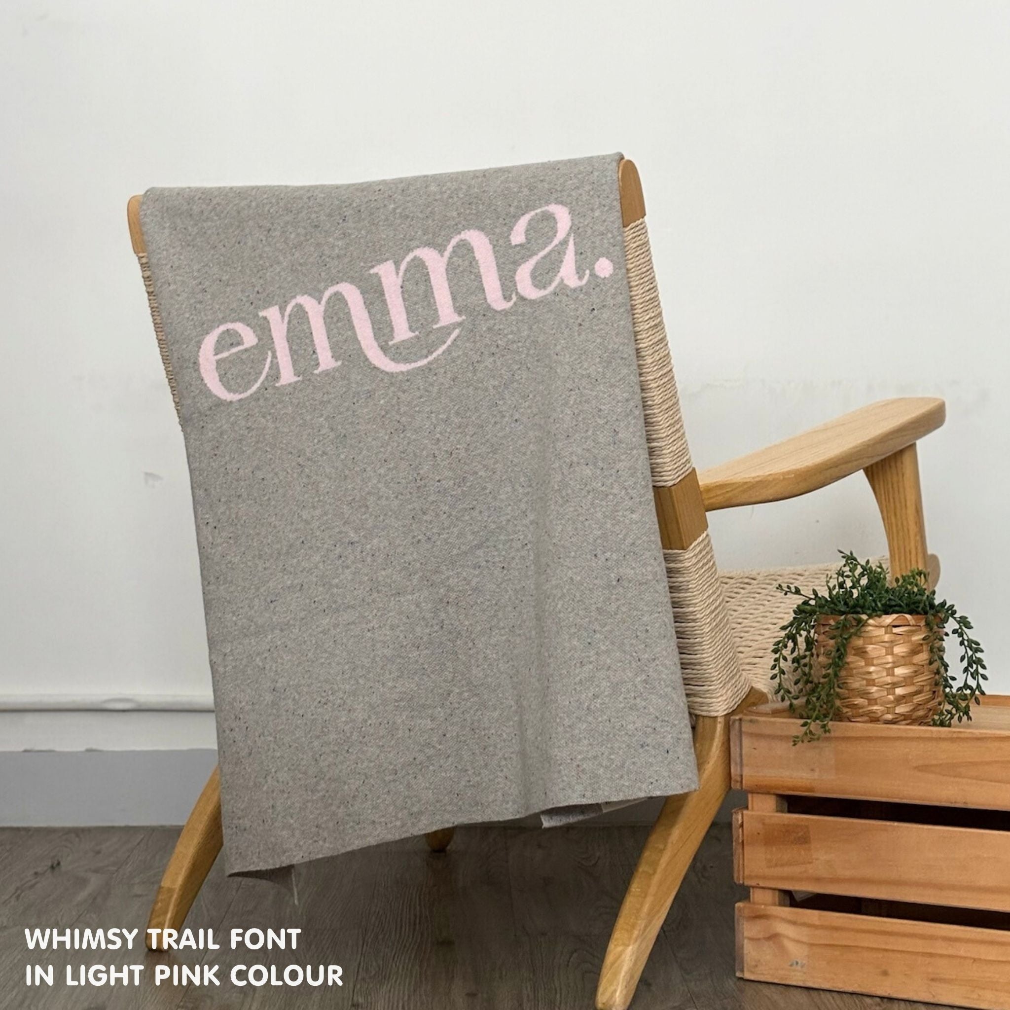 TinyBitz custom knitted blanket with baby's name on grey background with a confetti pattern, best gift to welcome a newborn baby.