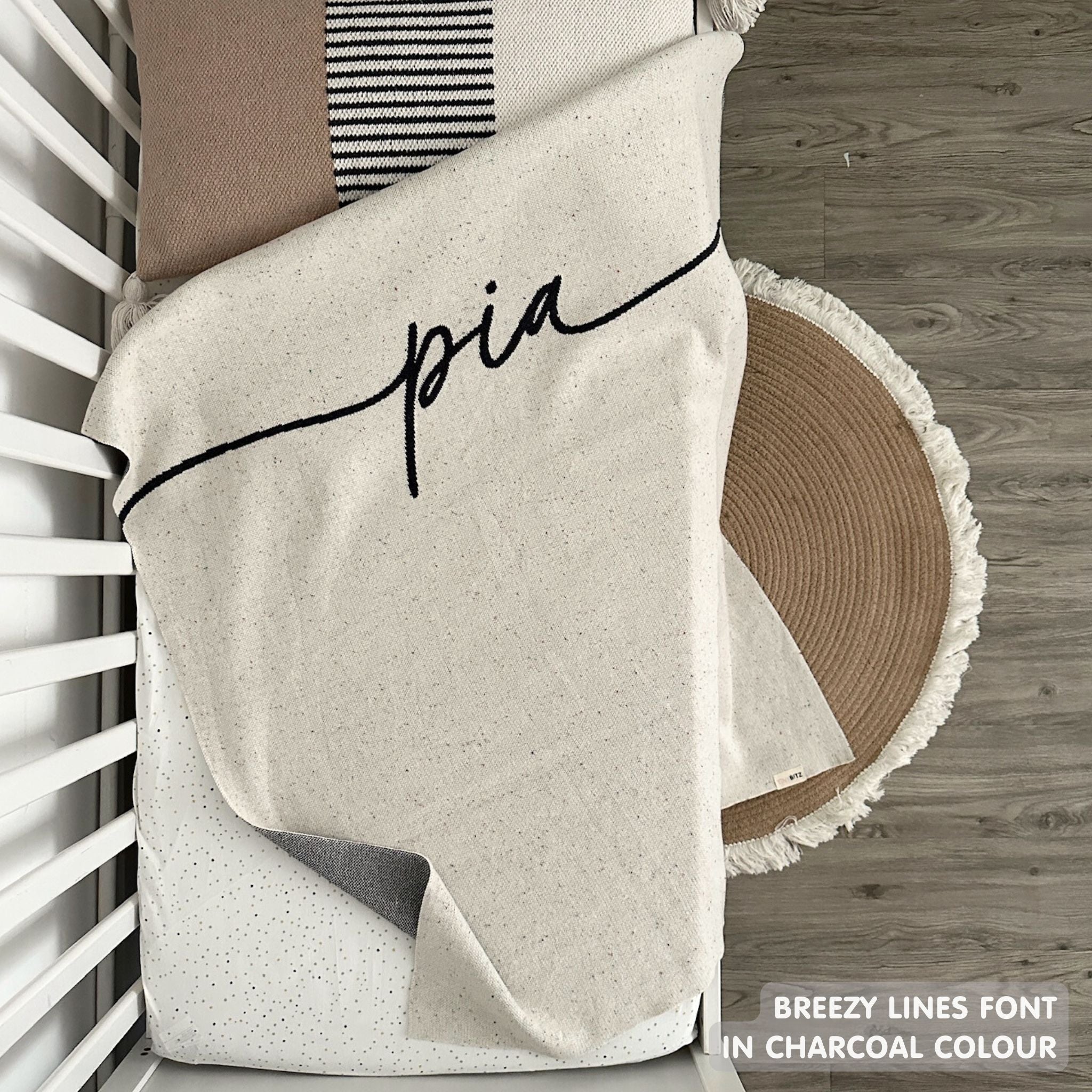 TinyBitz custom knitted blanket with baby's name on cream background with a confetti pattern, best gift to welcome a newborn baby.