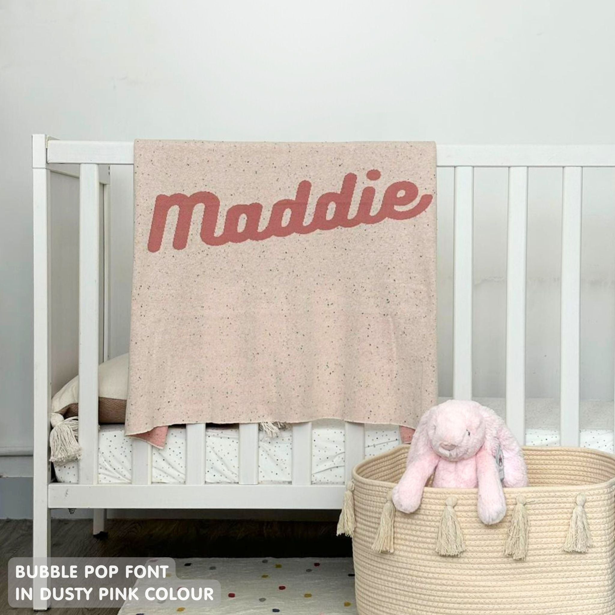 TinyBitz knitted name blanket in cream and dusty pink with a confetti pattern, a lovely touch to decorate your baby's room!
