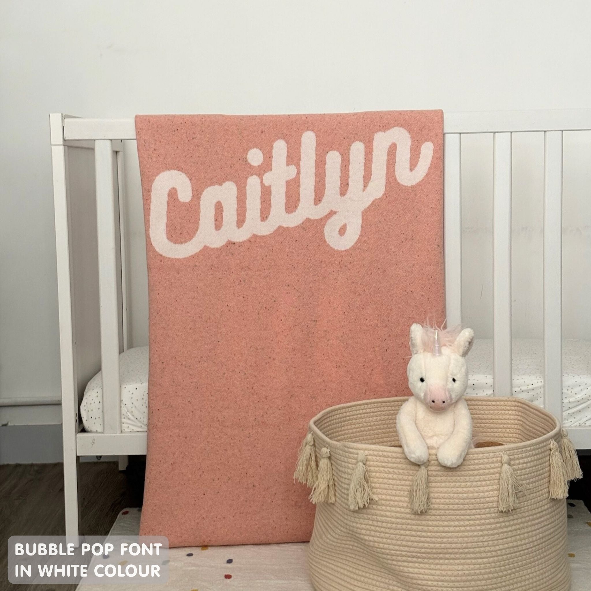 TinyBitz custom knitted blanket with baby's name on pink background with a confetti pattern, best gift to welcome a newborn baby.