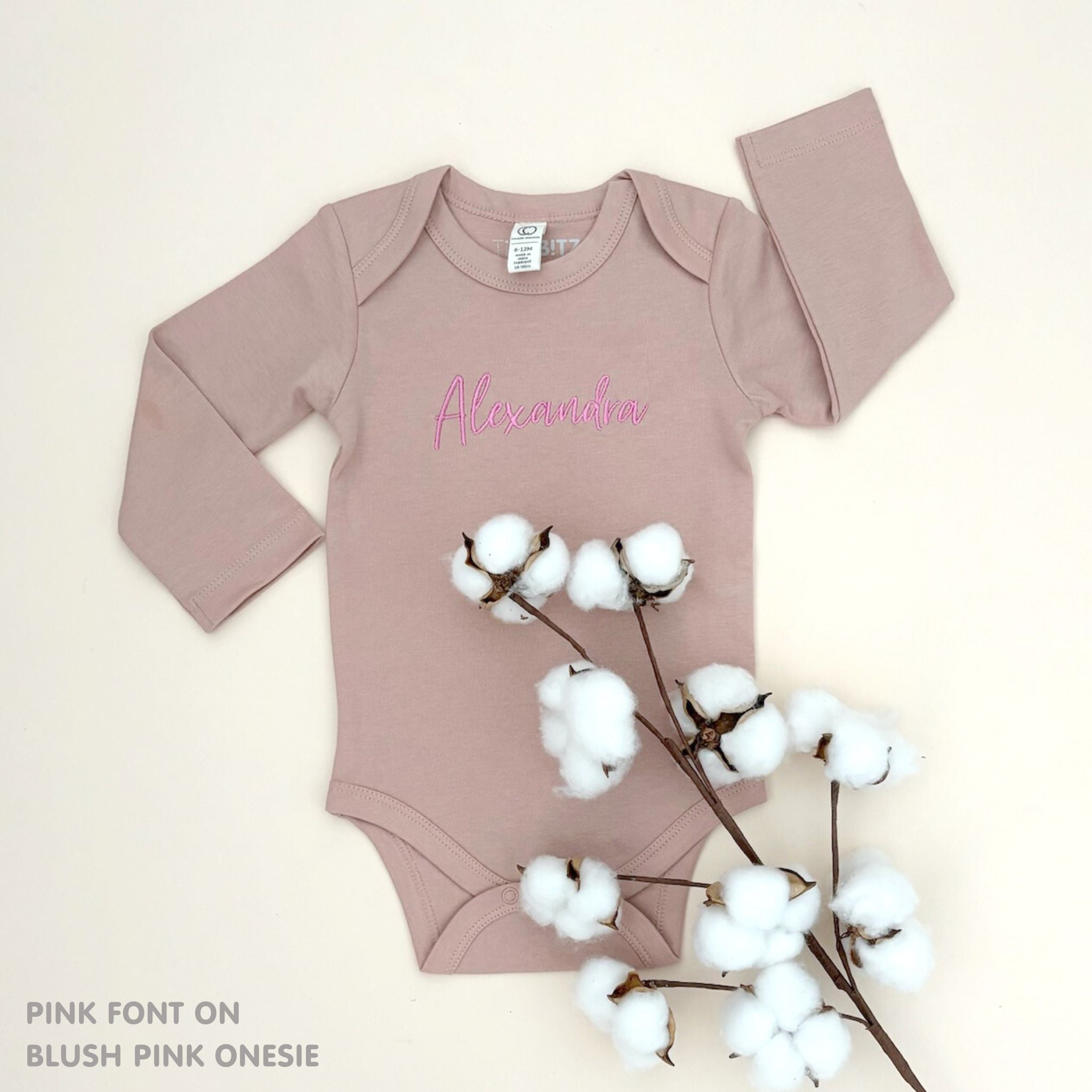 Organic cotton baby onesie with custom name, ideal for birth announcements, baby shower gifts, and keepsakes by TinyBitz.
