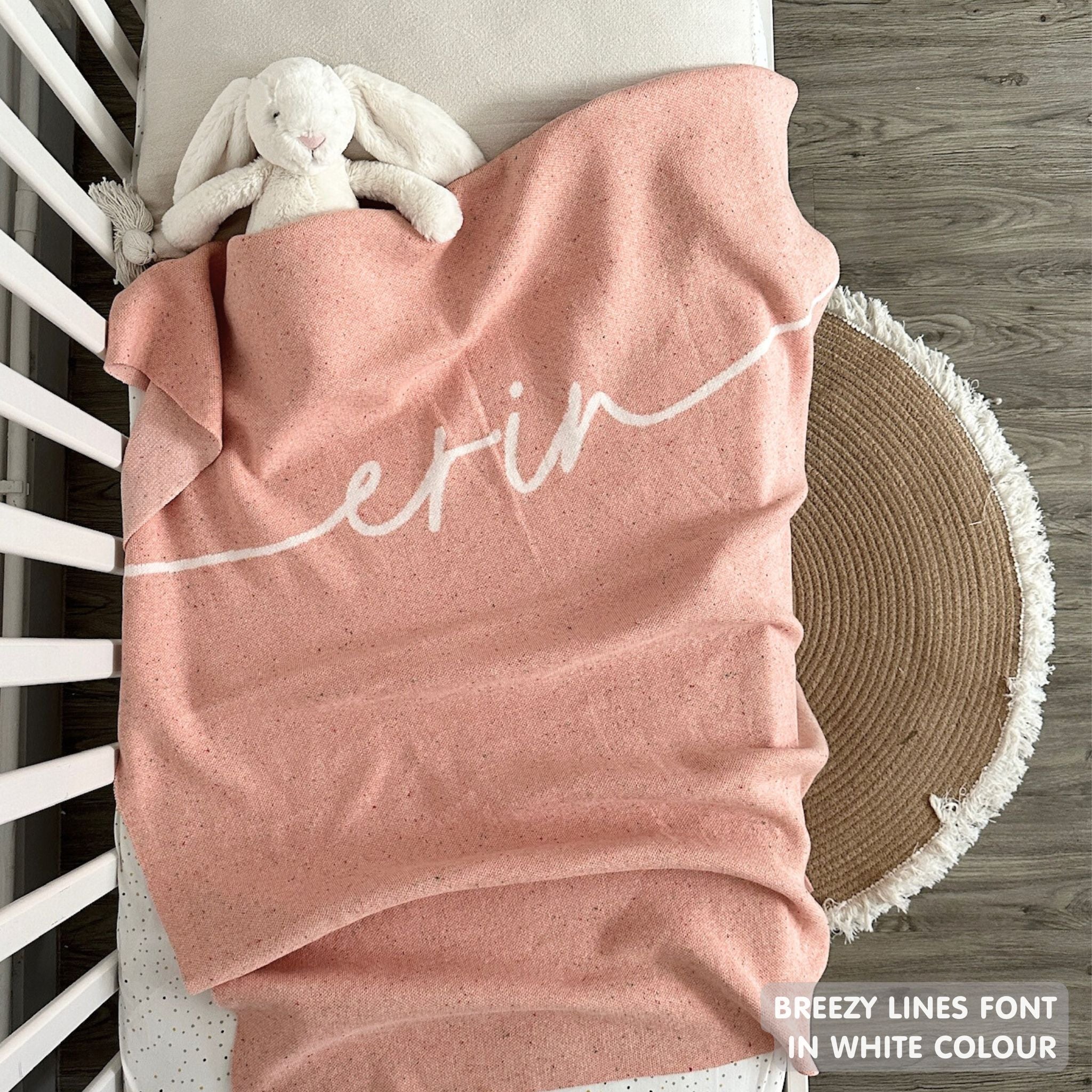 Knitted baby blanket in pink and white with a confetti pattern, customised with baby's name, made by TinyBitz.