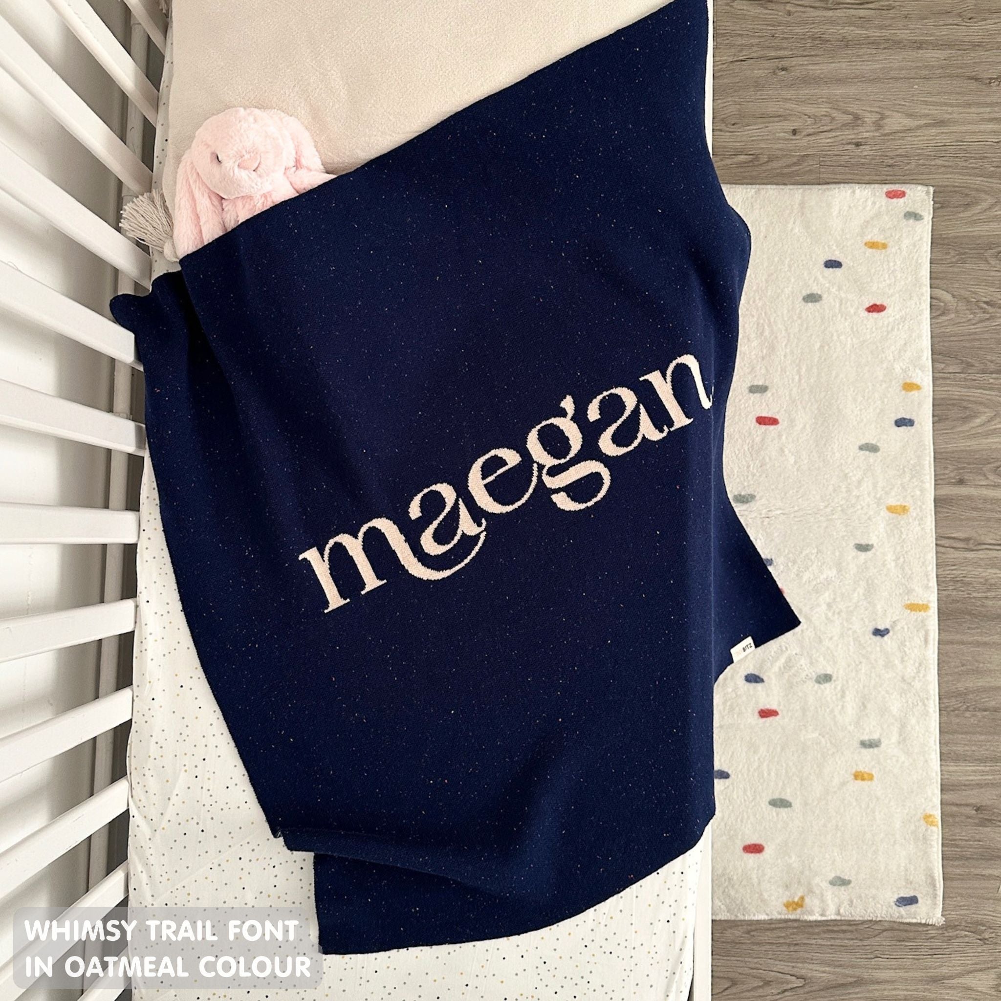 Baby blanket knitted from cotton personalized with baby's name in navy and oatmeal with a confetti pattern, made by TinyBitz.