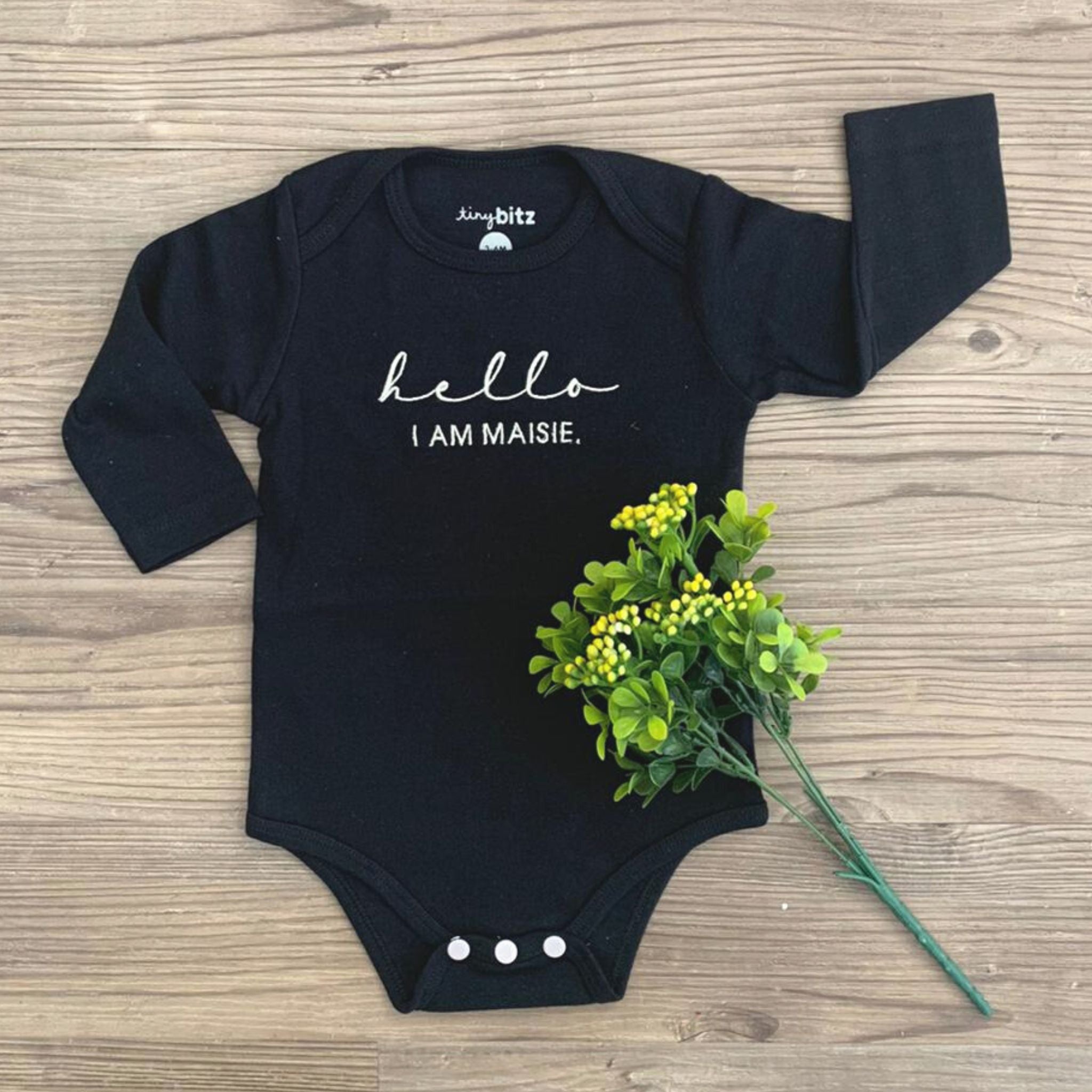 TinyBitz Custom baby onesie in black with name embroidery, unique outfit for baby’s birth announcement or first photoshoot.