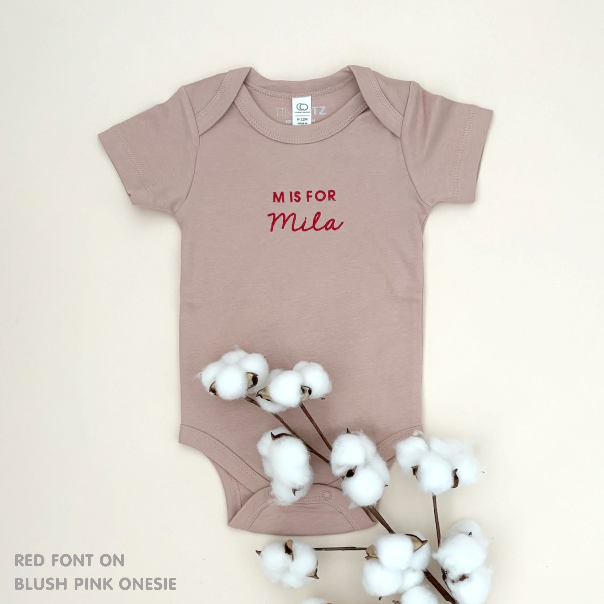 Custom name onesie in blush pink, personalised baby clothing made with soft breathable fabric by TinyBitz.