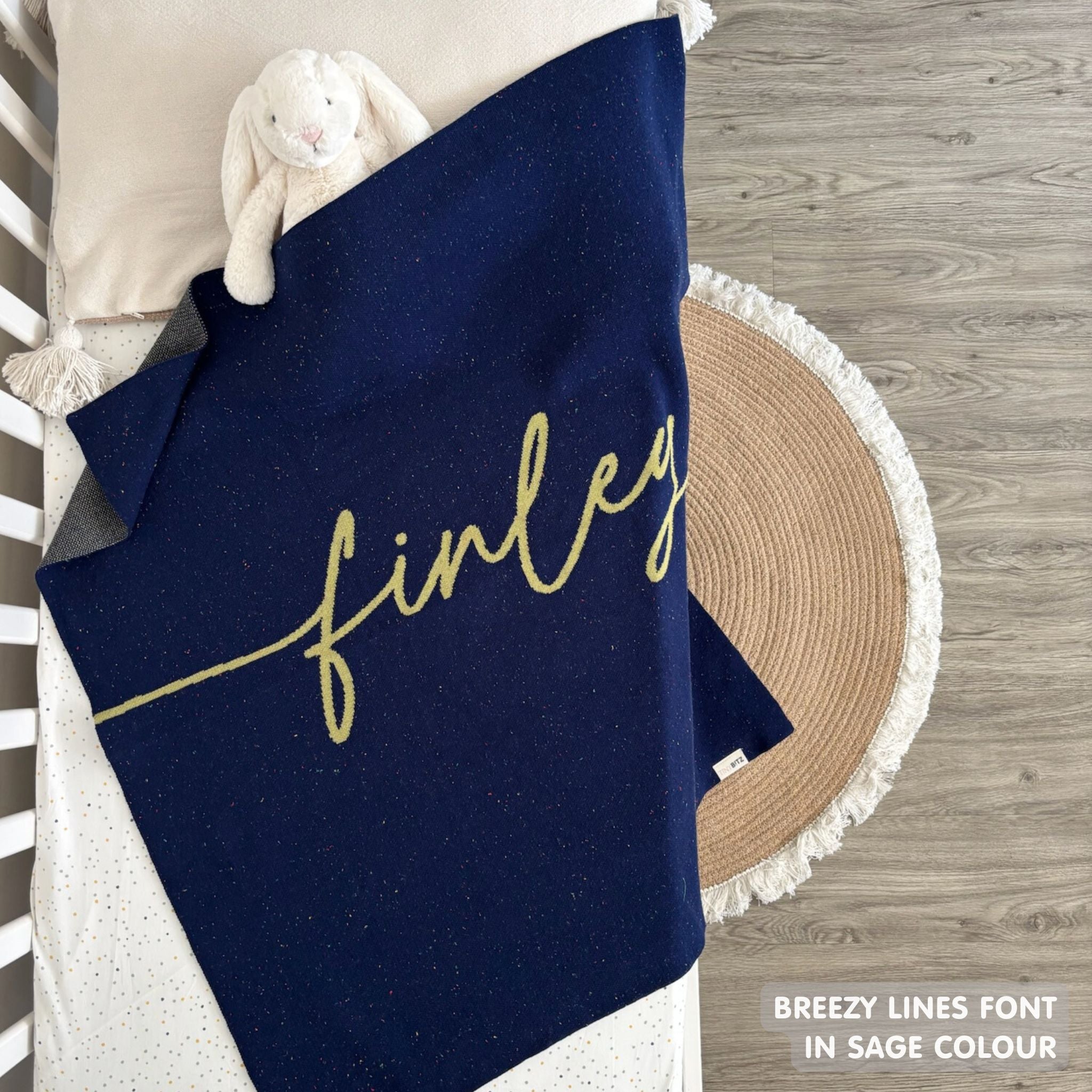 TinyBitz custom knitted blanket with baby's name on navy background with a confetti pattern, best gift to welcome a newborn baby.