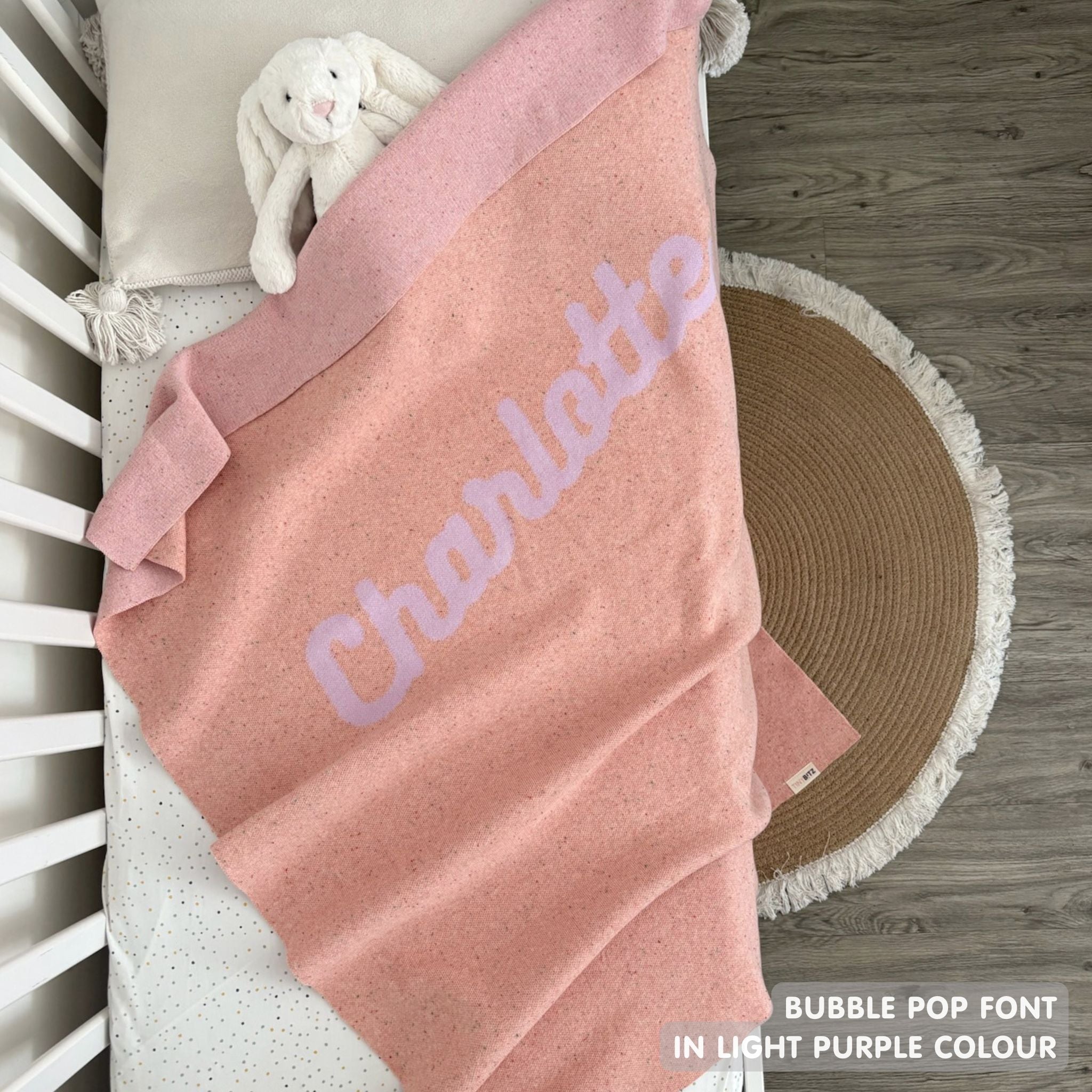 TinyBitz personalized kids knitted name blanket in pink and light purple with a confetti pattern, perfect gift for birthdays!