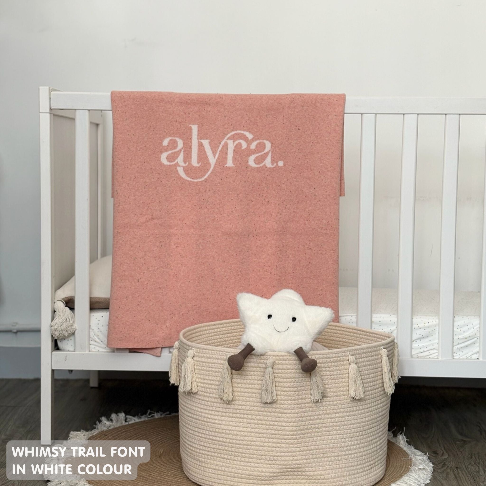 Baby blanket knitted from cotton personalized with baby's name in pink and white with a confetti pattern, made by TinyBitz.