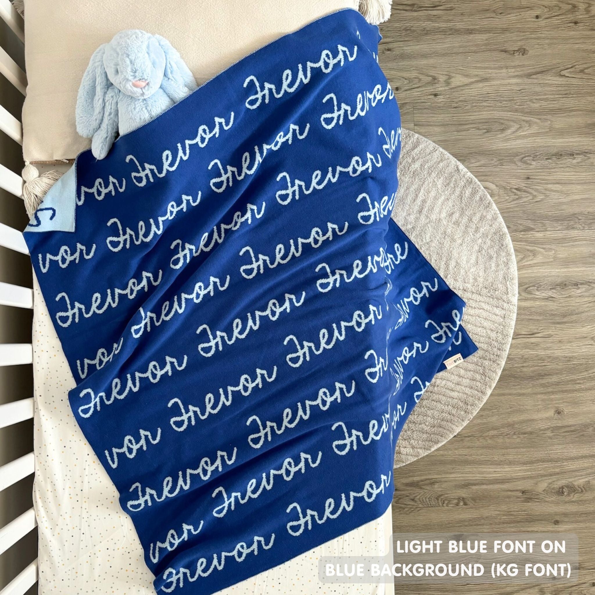 TinyBitz personalized knitted blanket in blue background, customized with baby's name and made from 100% cotton.