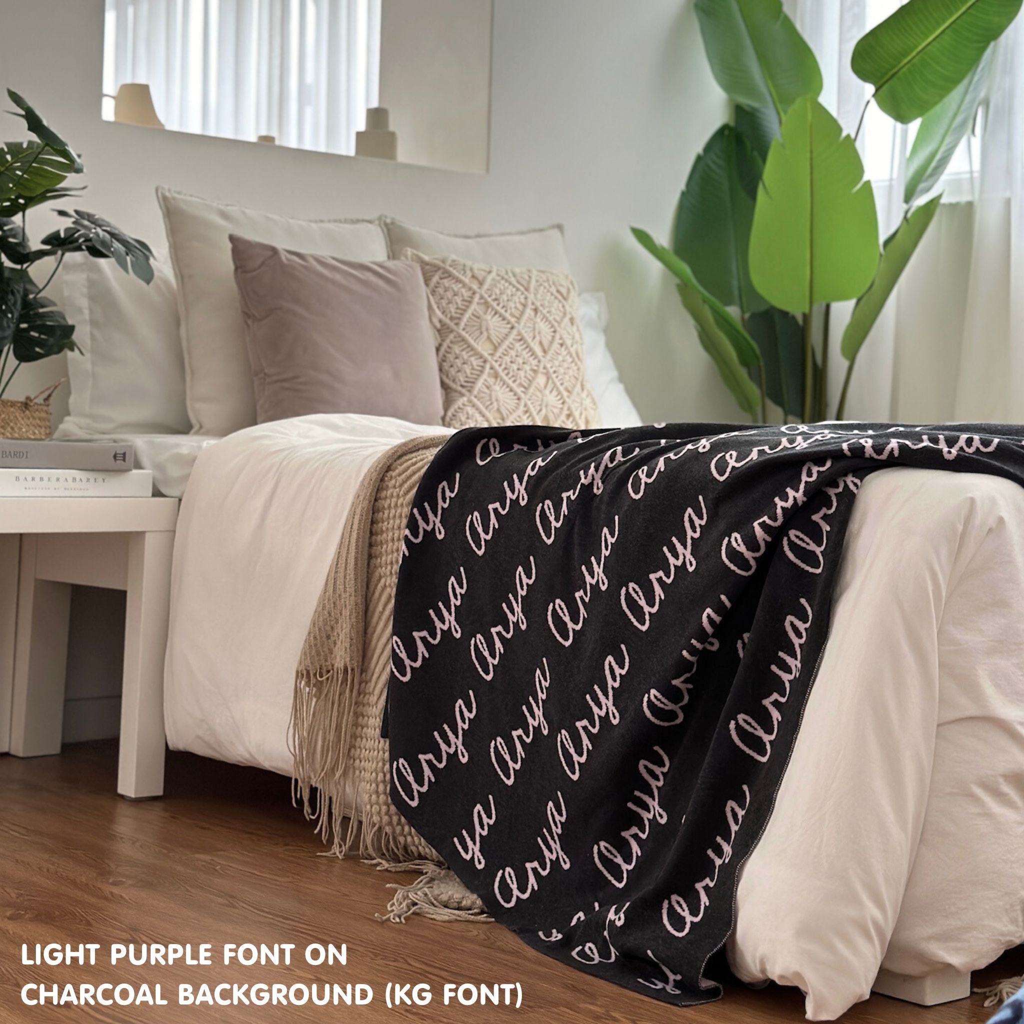 Custom name blanket draped on sofa, knitted in charcoal and light purple makes the best personalised home decor.