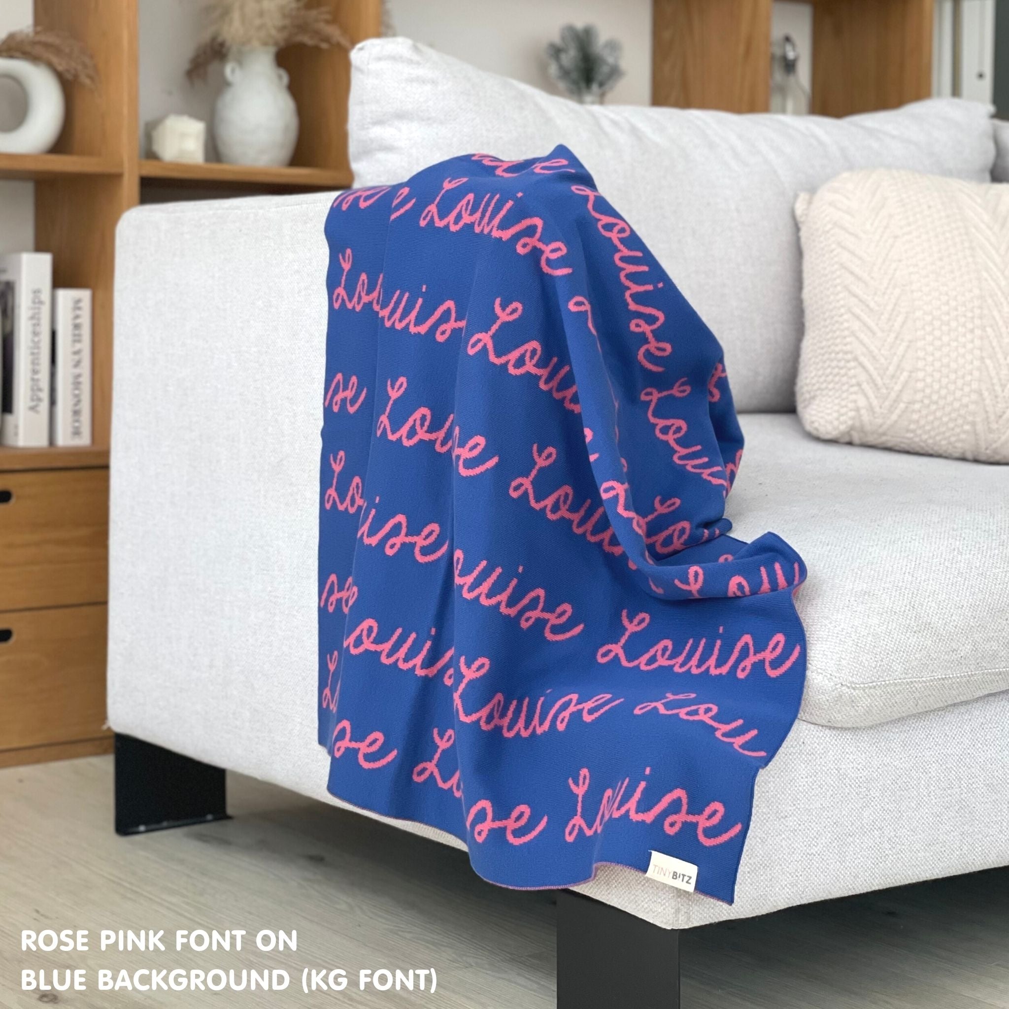 Customisable sofa throw and blanket with your own name knitted in blue and rose pink, made by TinyBitz!