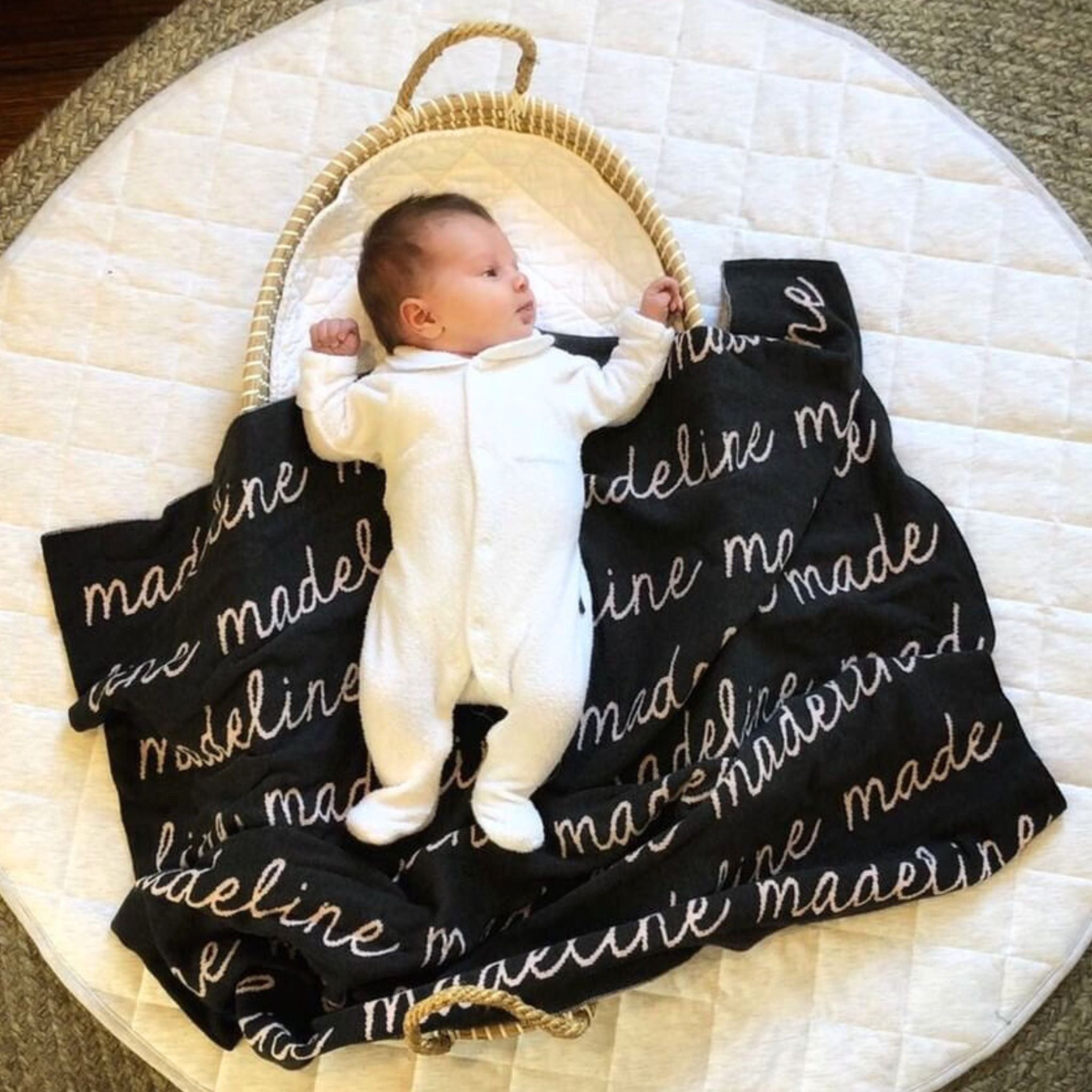 Knitted baby blanket in charcoal background, customised with baby's name, made by TinyBitz.