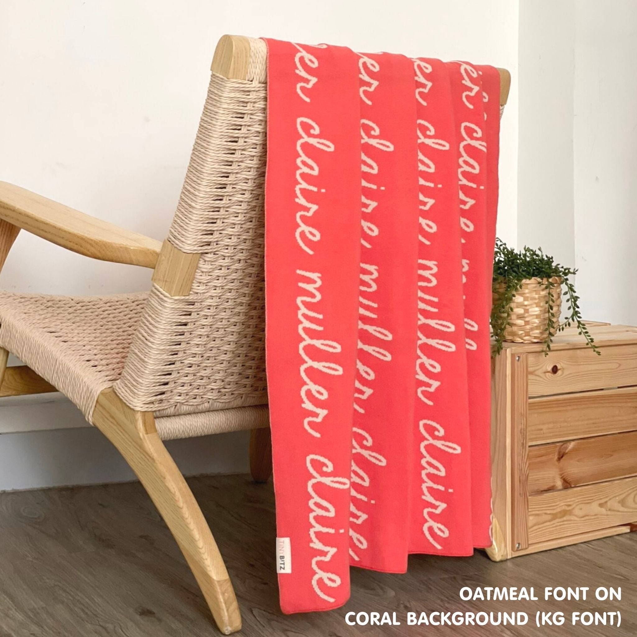 Customisable blanket with adult's name knitted in coral and oatmeal, personalized by TinyBitz.