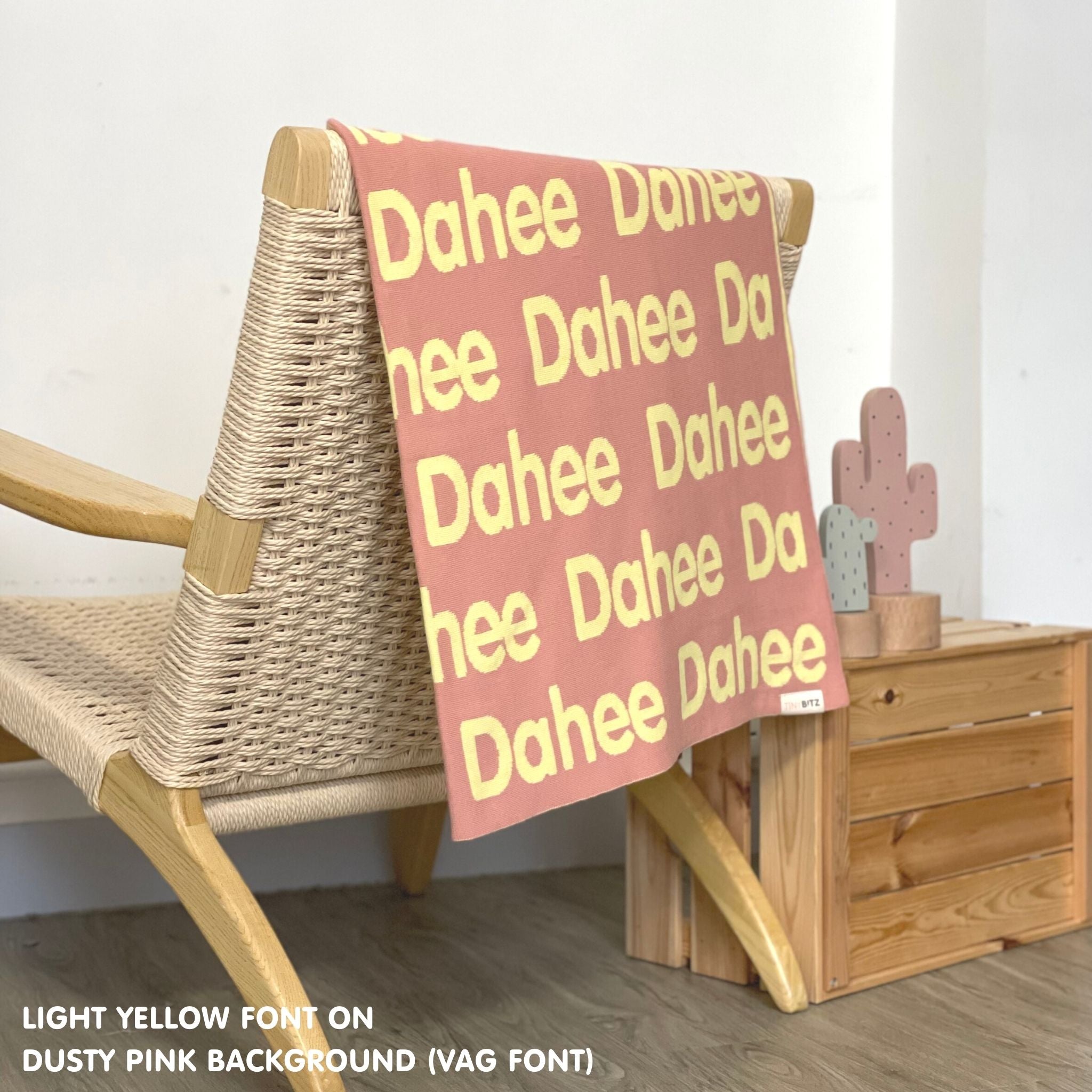 TinyBitz knitted name blanket in dusty pink and light yellow can be used to decorate your baby's room!