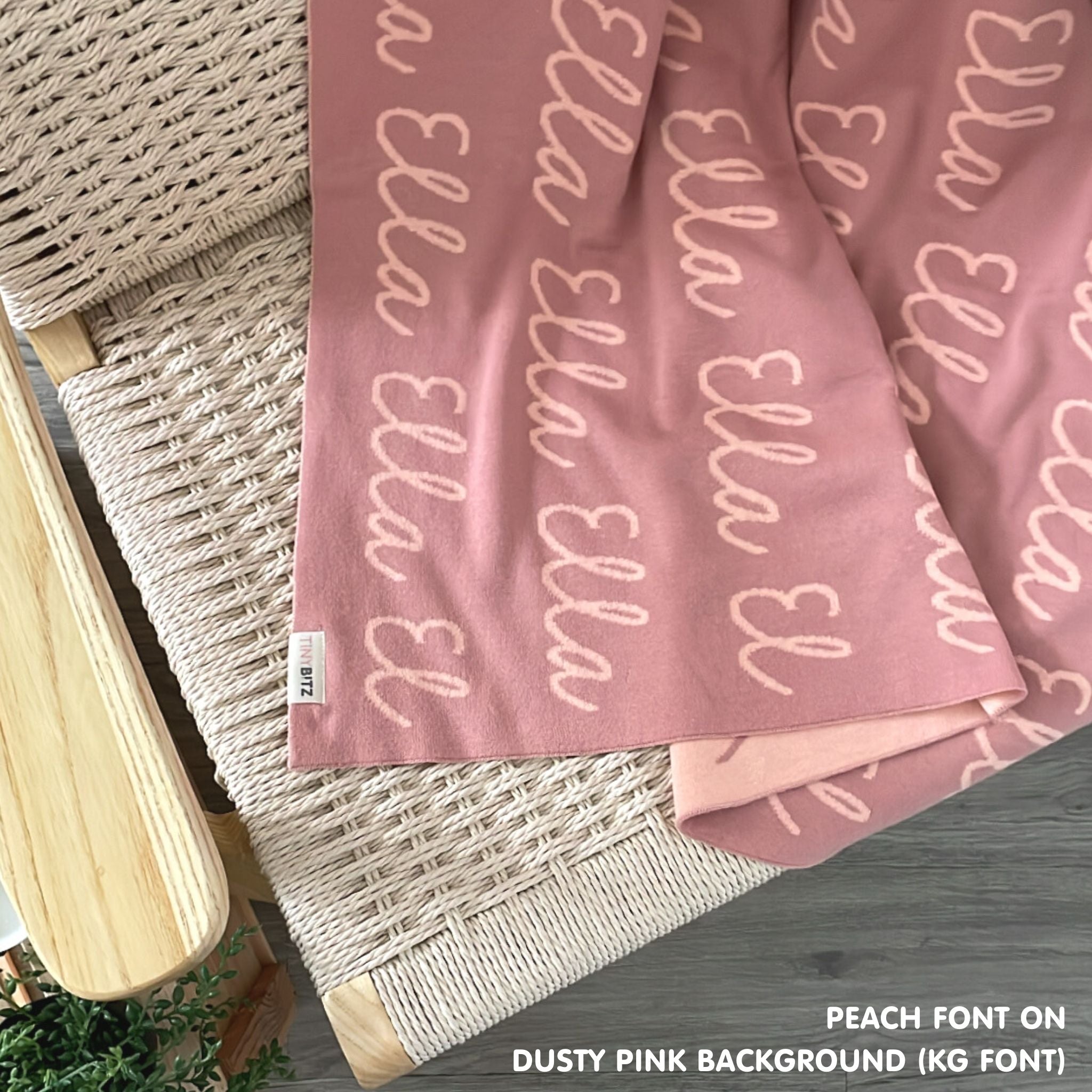 Customisable blanket with adult's name knitted in dusty pink and peach, personalized by TinyBitz.