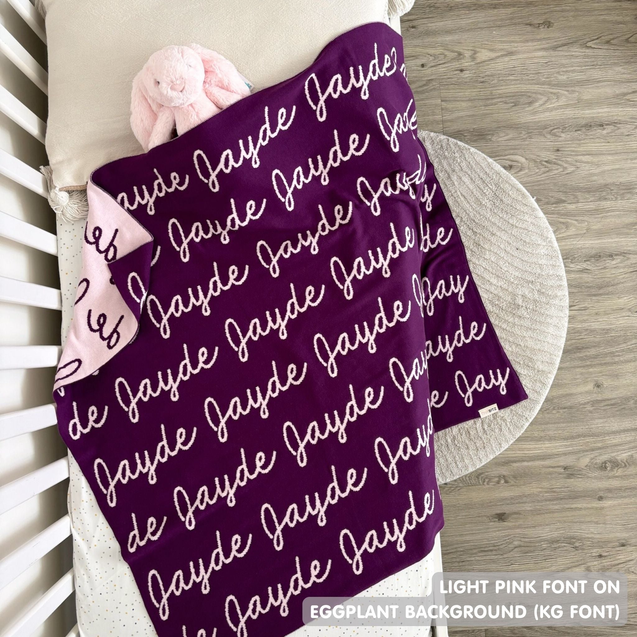 Knitted baby blanket in eggplant and light pink, customised with baby's name, made by TinyBitz.