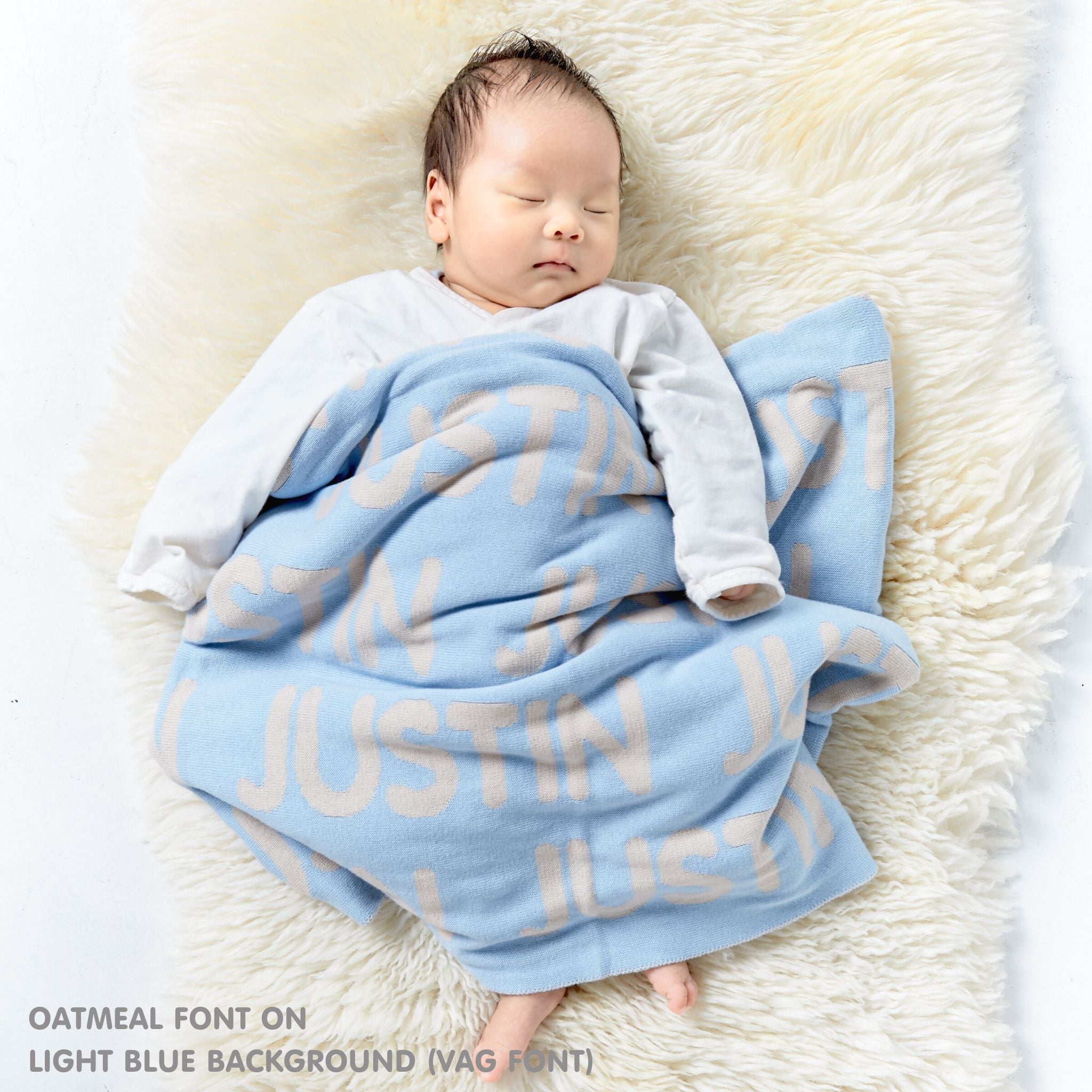 TinyBitz personalized knitted blanket in light blue background, customized with baby's name and made from 100% cotton.