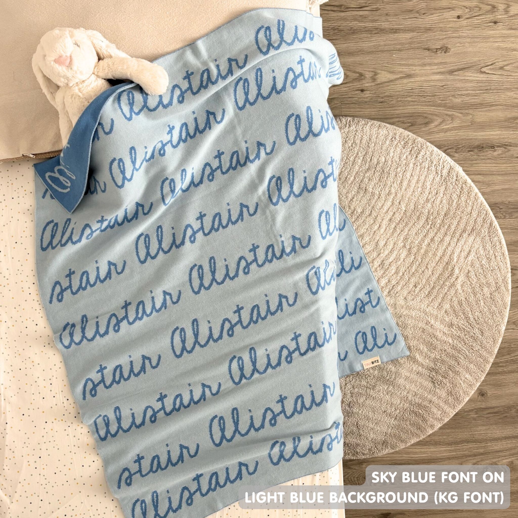 TinyBitz knitted baby boys blanket in light blue background and sky blue, personalized with your baby’s name.