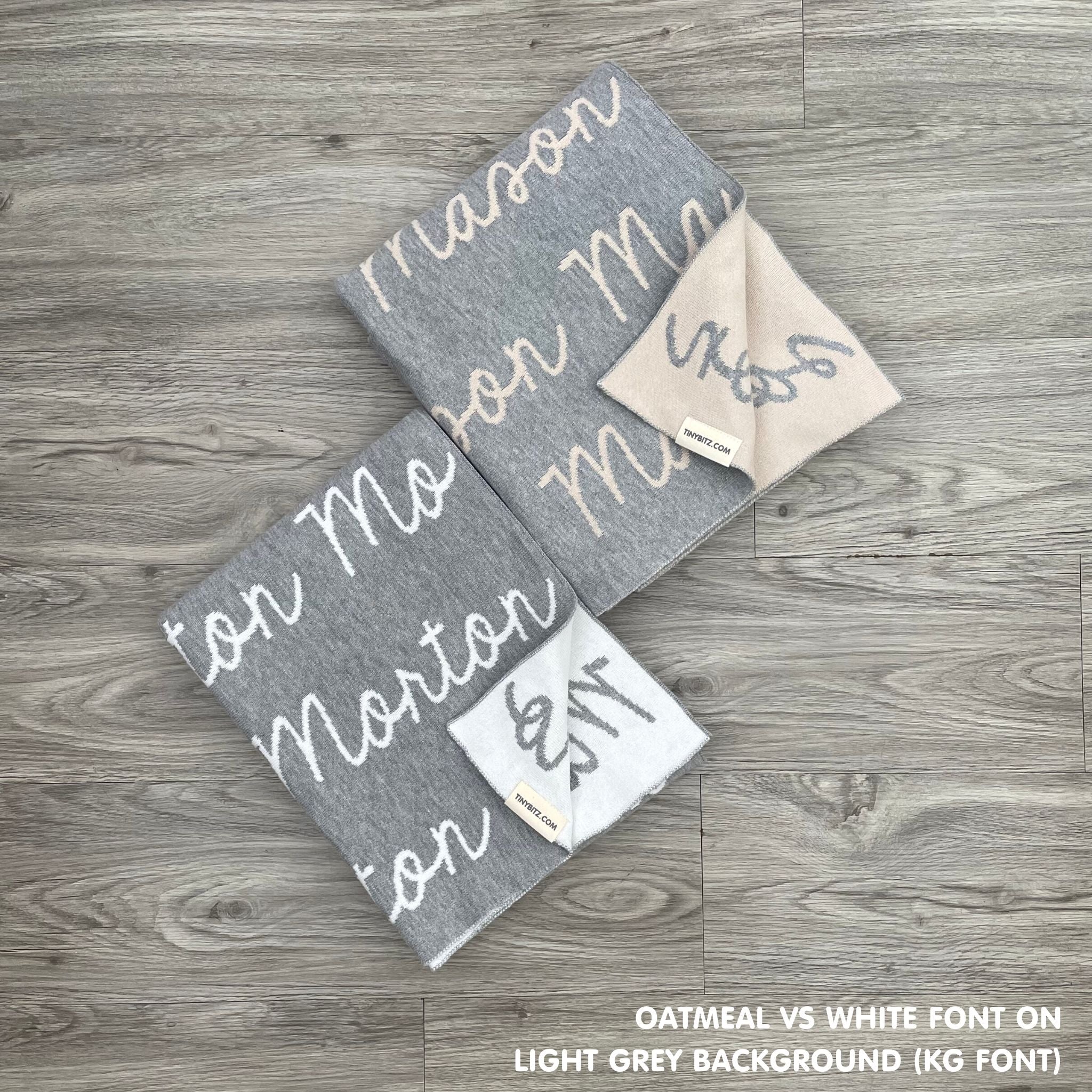 Baby blanket knitted from cotton personalized with baby's name in light grey background, made by TinyBitz.