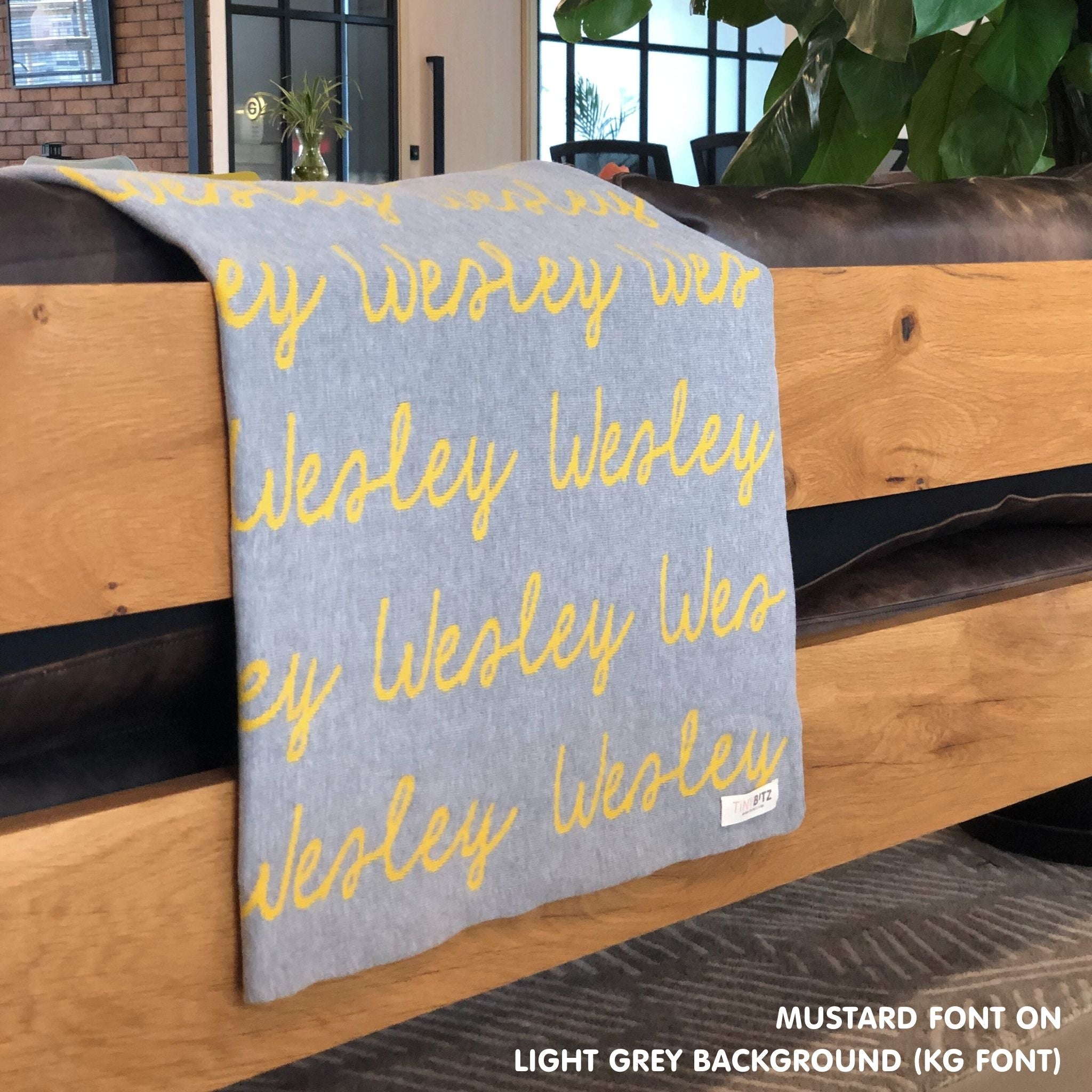 TinyBitz Personalized name blanket in light grey and mustard, perfect gift for newborn babies.