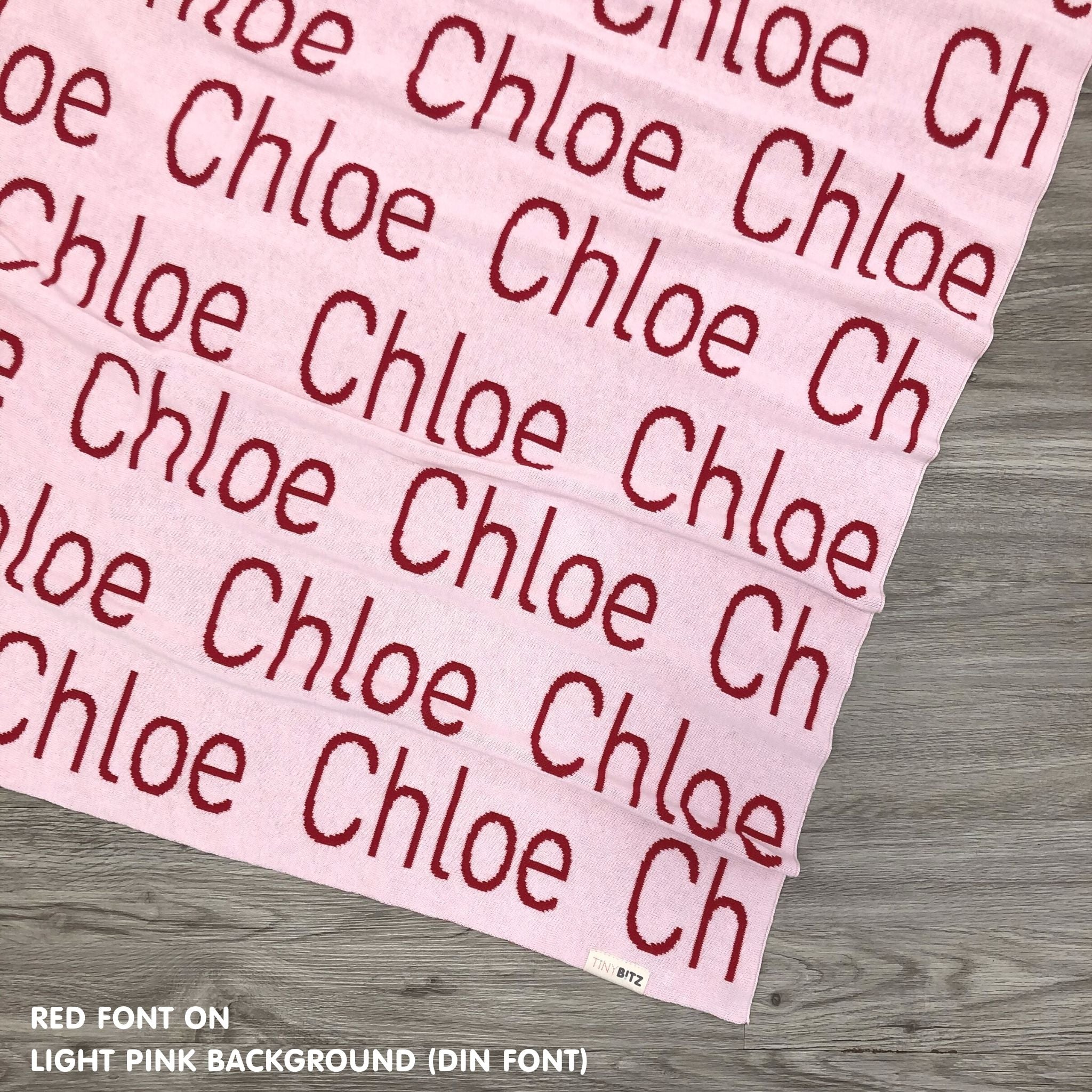 Personalised blanket for adult knitted from cotton in light pink and red, custom made by TinyBitz.