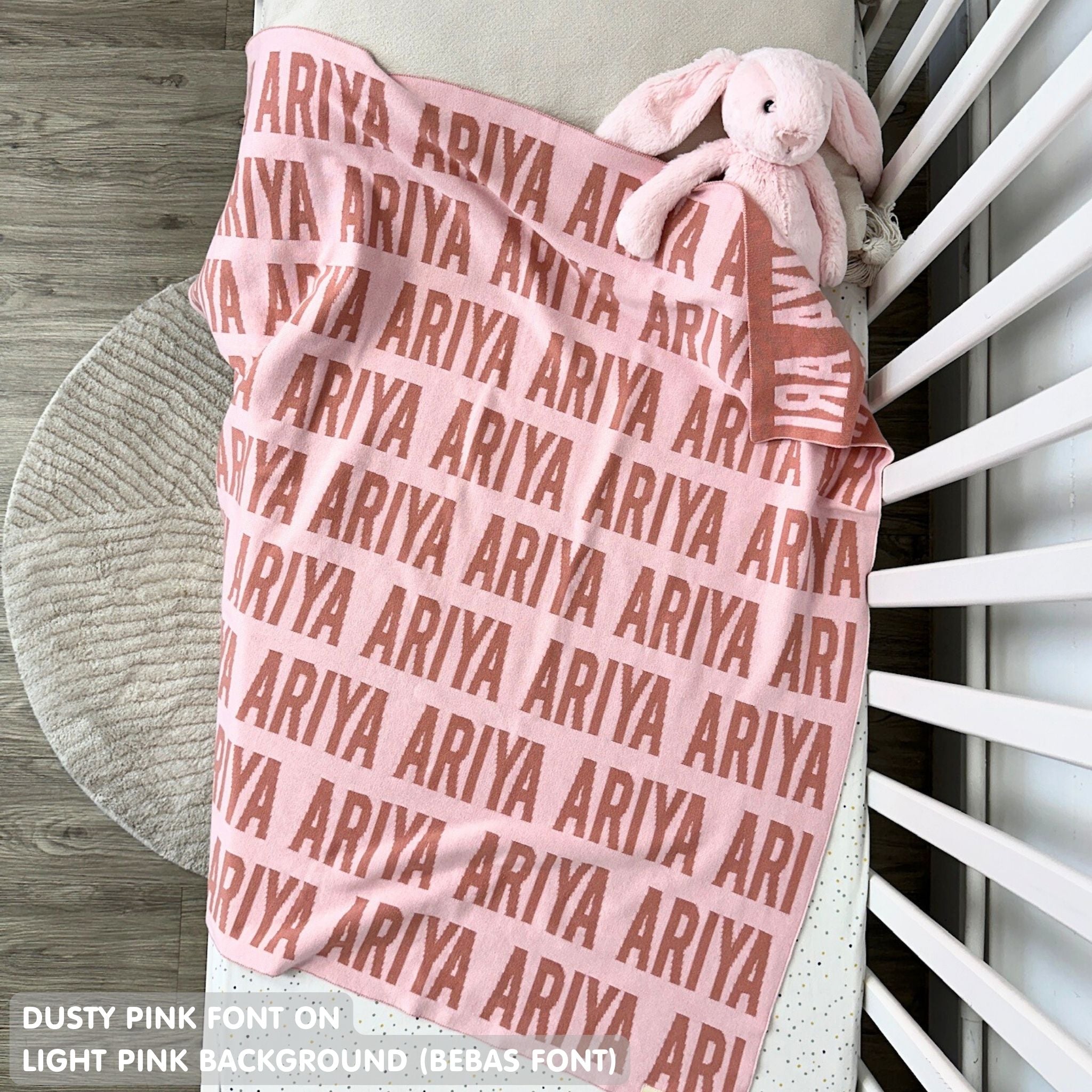 Cotton baby blanket with baby's name knitted in light pink and dusty pink, made by TinyBitz.