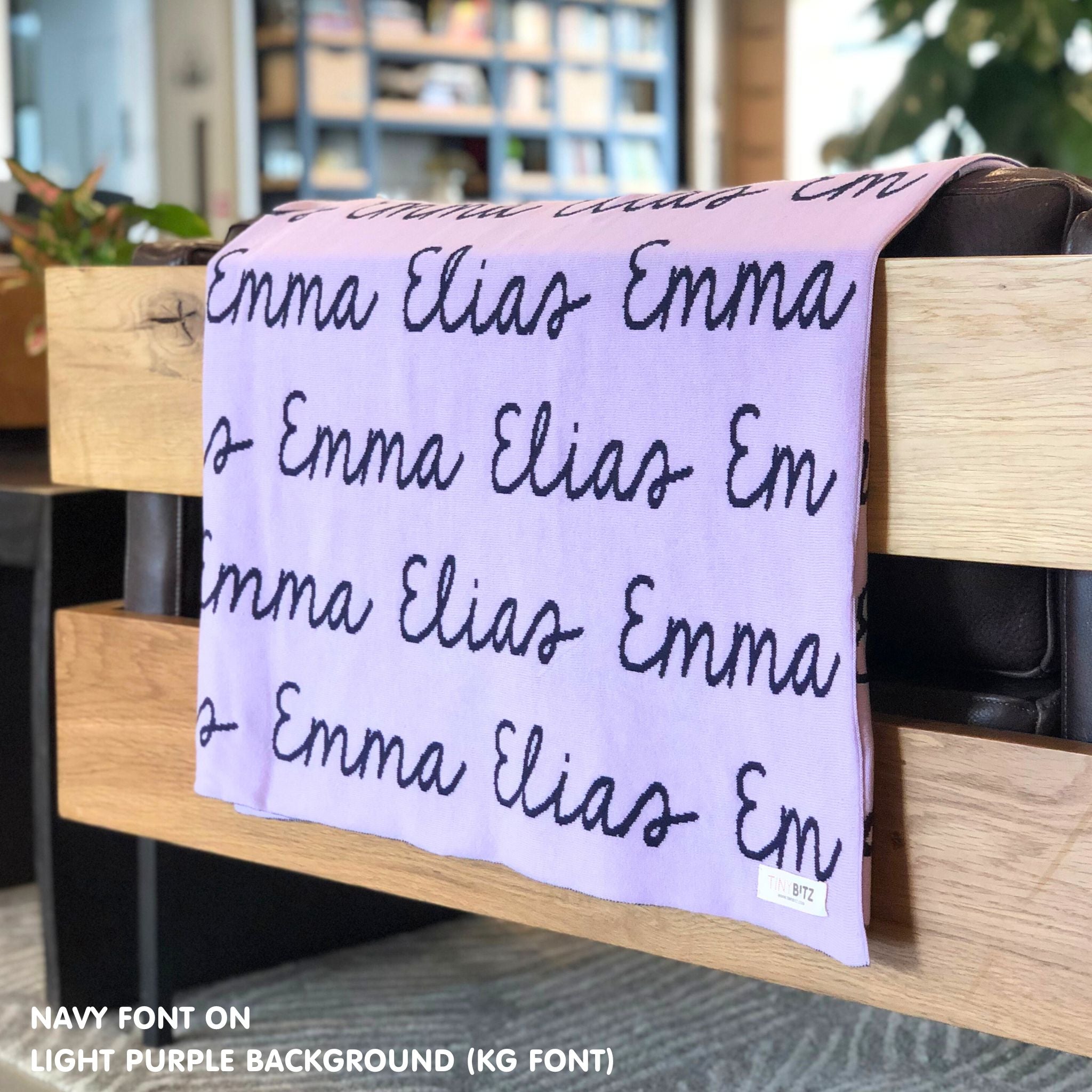Custom name blanket in light purple and navy draped over a chair makes the best personalized home decor.