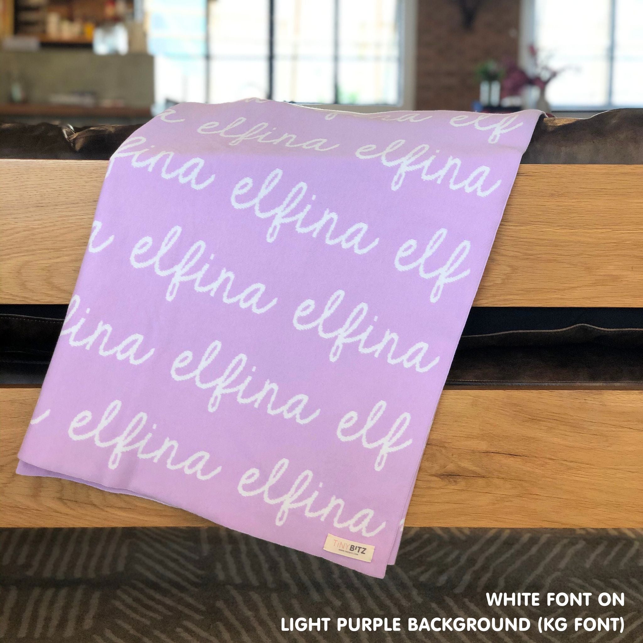 Custom name blanket in light purple and white draped over a chair makes the best personalized home decor.