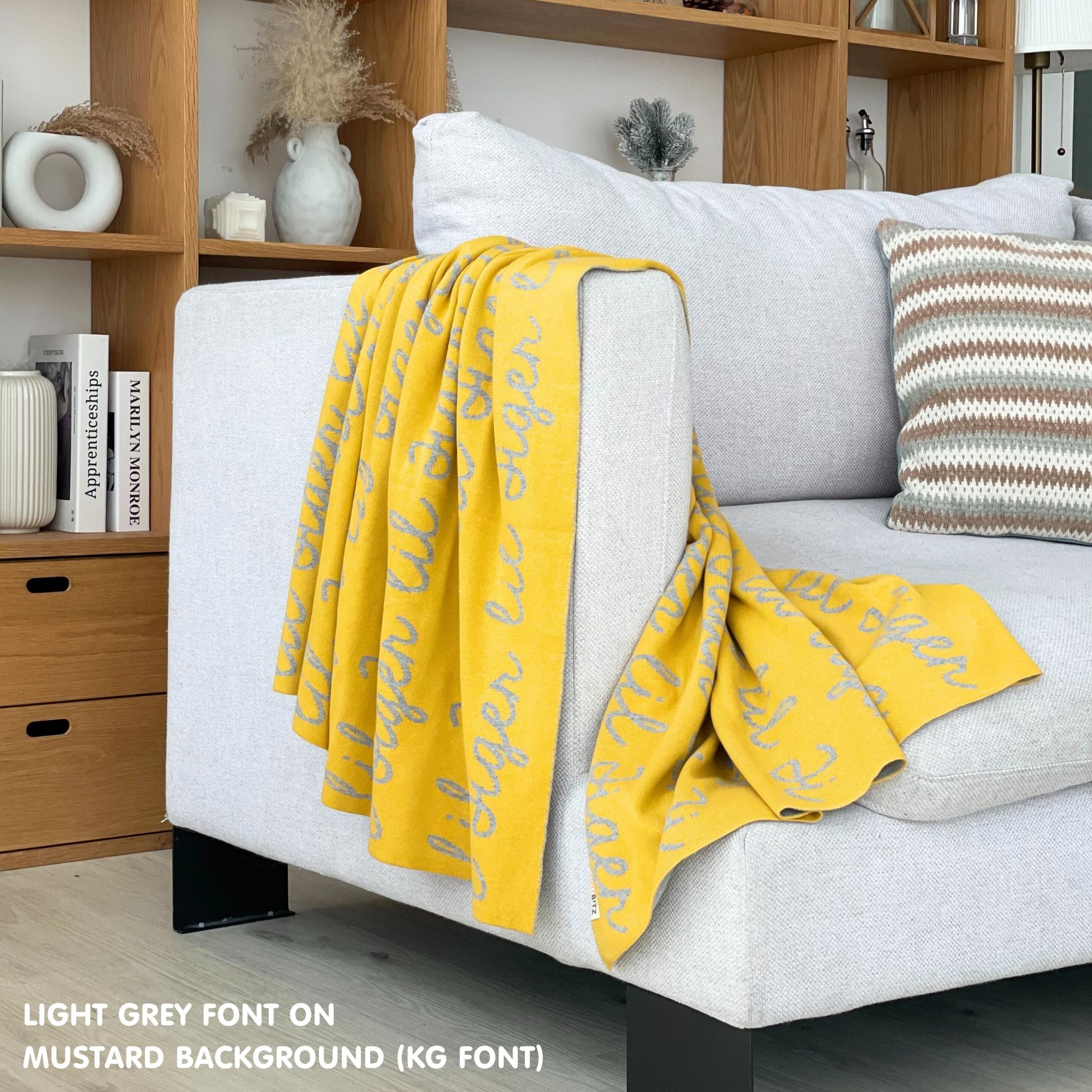 Customisable sofa throw and blanket with your own name knitted in mustard and light grey, made by TinyBitz!