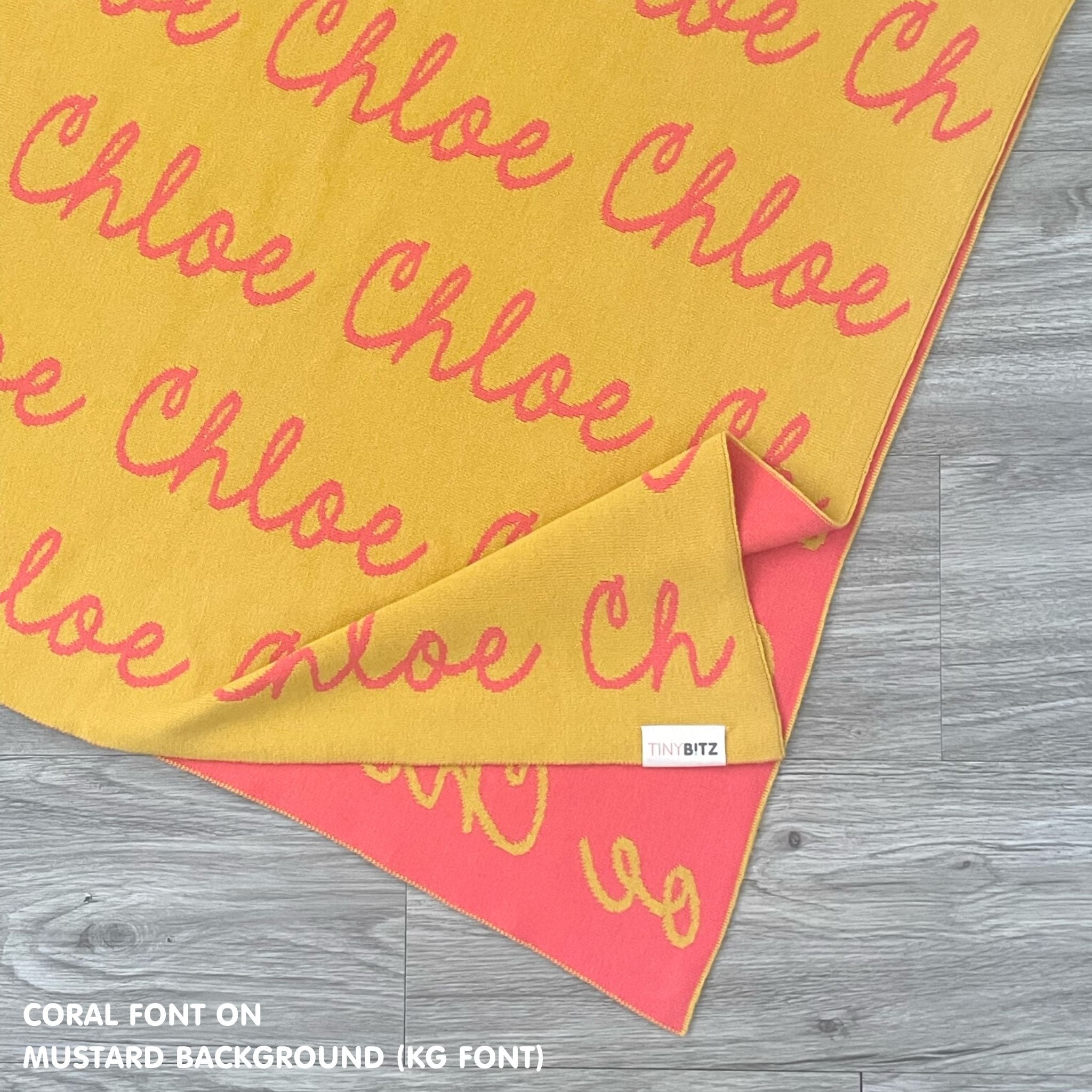 Personalised blanket for adult knitted from cotton in mustard and coral, custom made by TinyBitz.