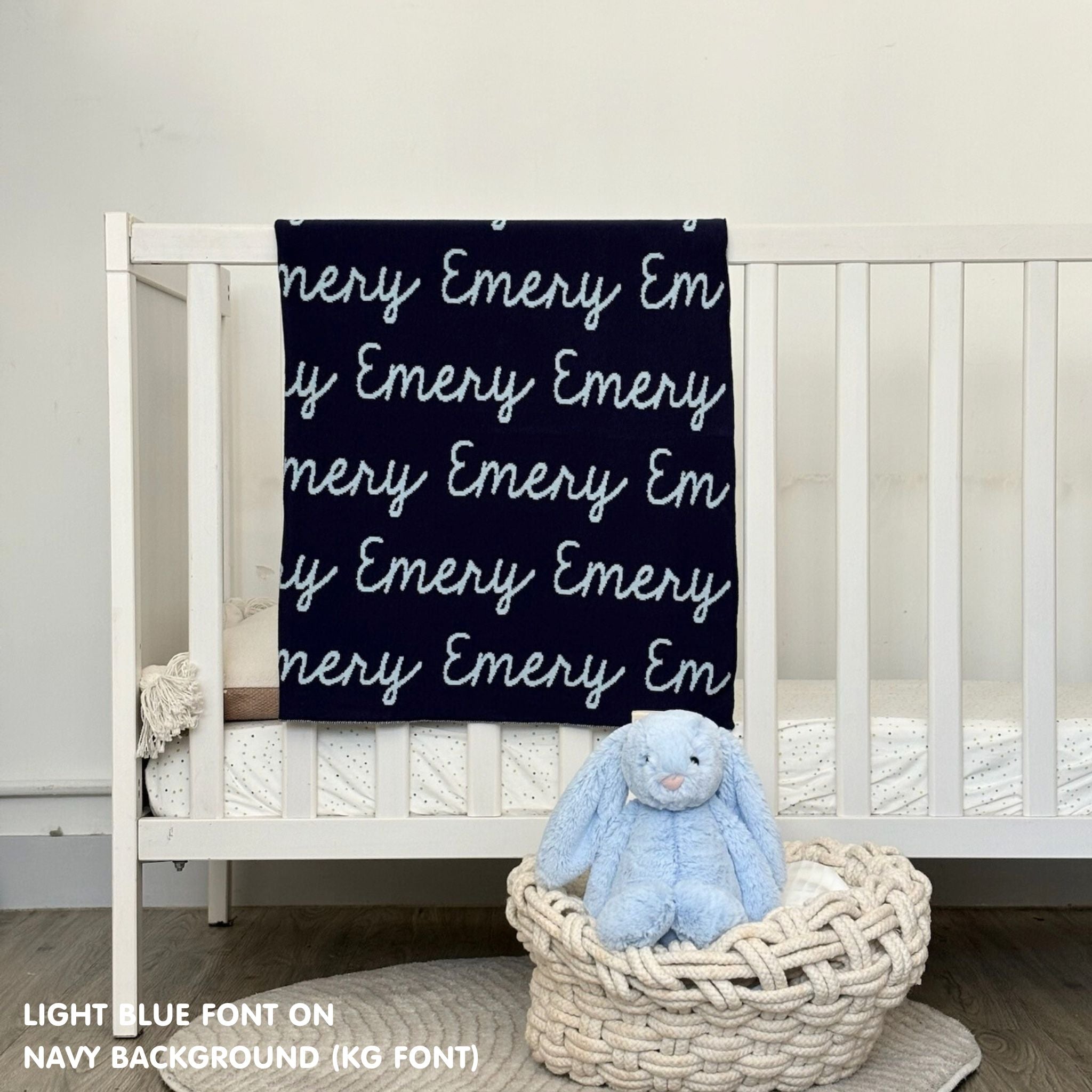 Cotton baby blanket with baby's name knitted in navy and light blue, made by TinyBitz.