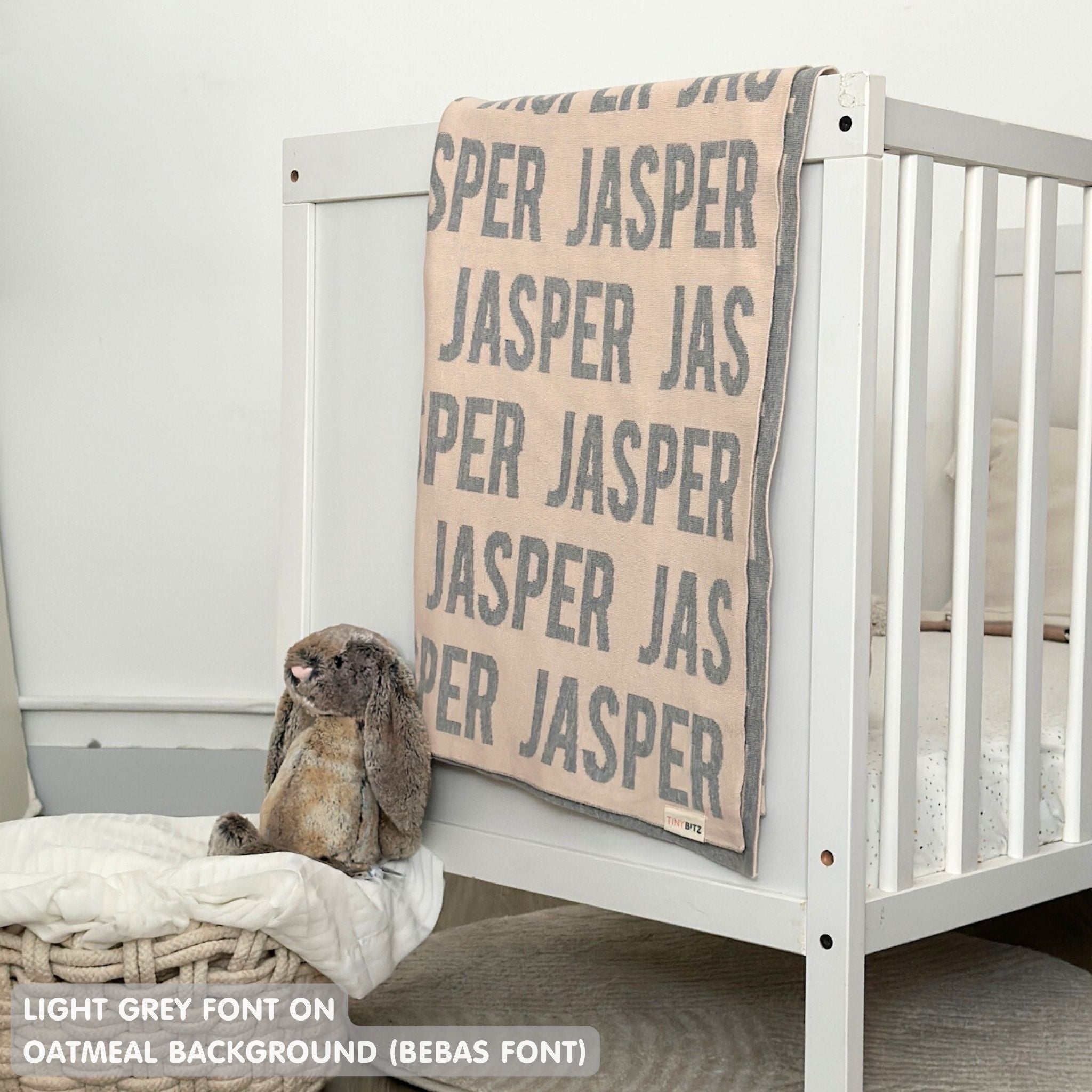 TinyBitz knitted baby boy blanket in oatmeal background and light grey, personalized with your baby’s name.