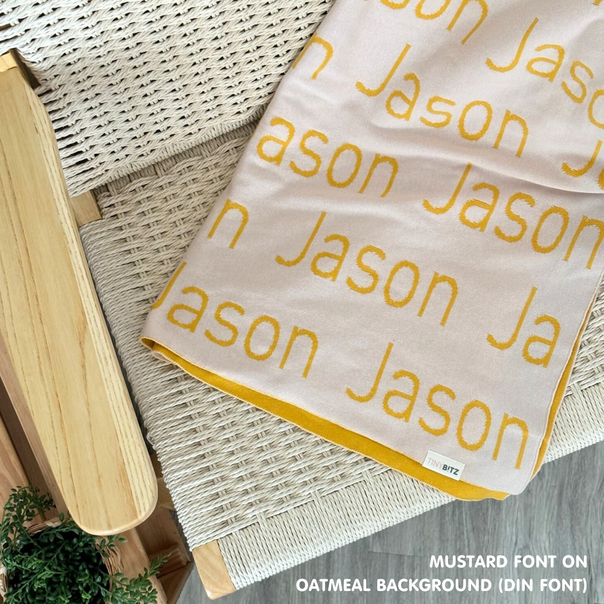 Personalised pet blanket in oatmeal and mustard knitted cotton, custom dog blanket by TinyBitz, styled on modern wooden dog bed.