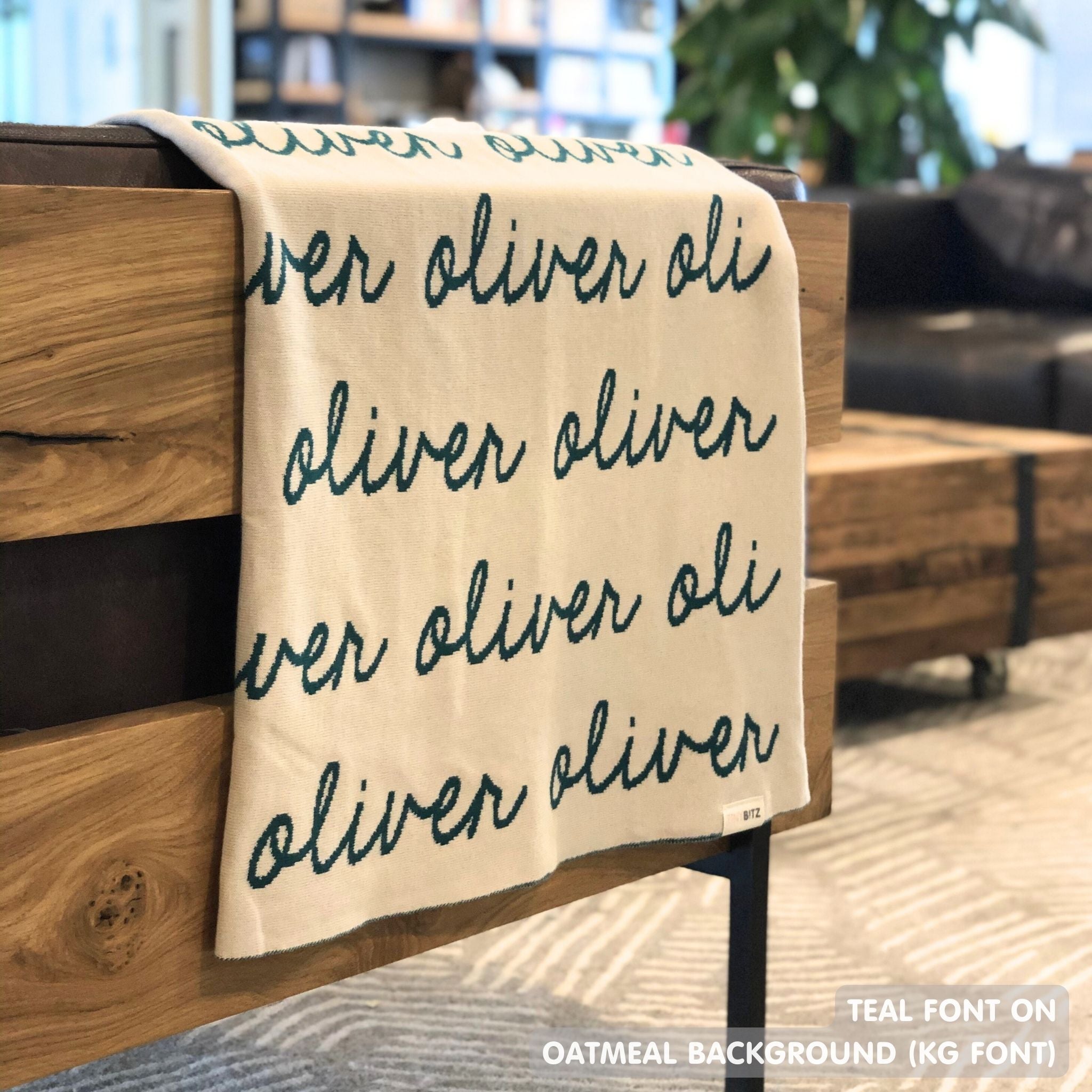 Custom name blanket in oatmeal and teal draped over a chair makes the best personalized home decor.