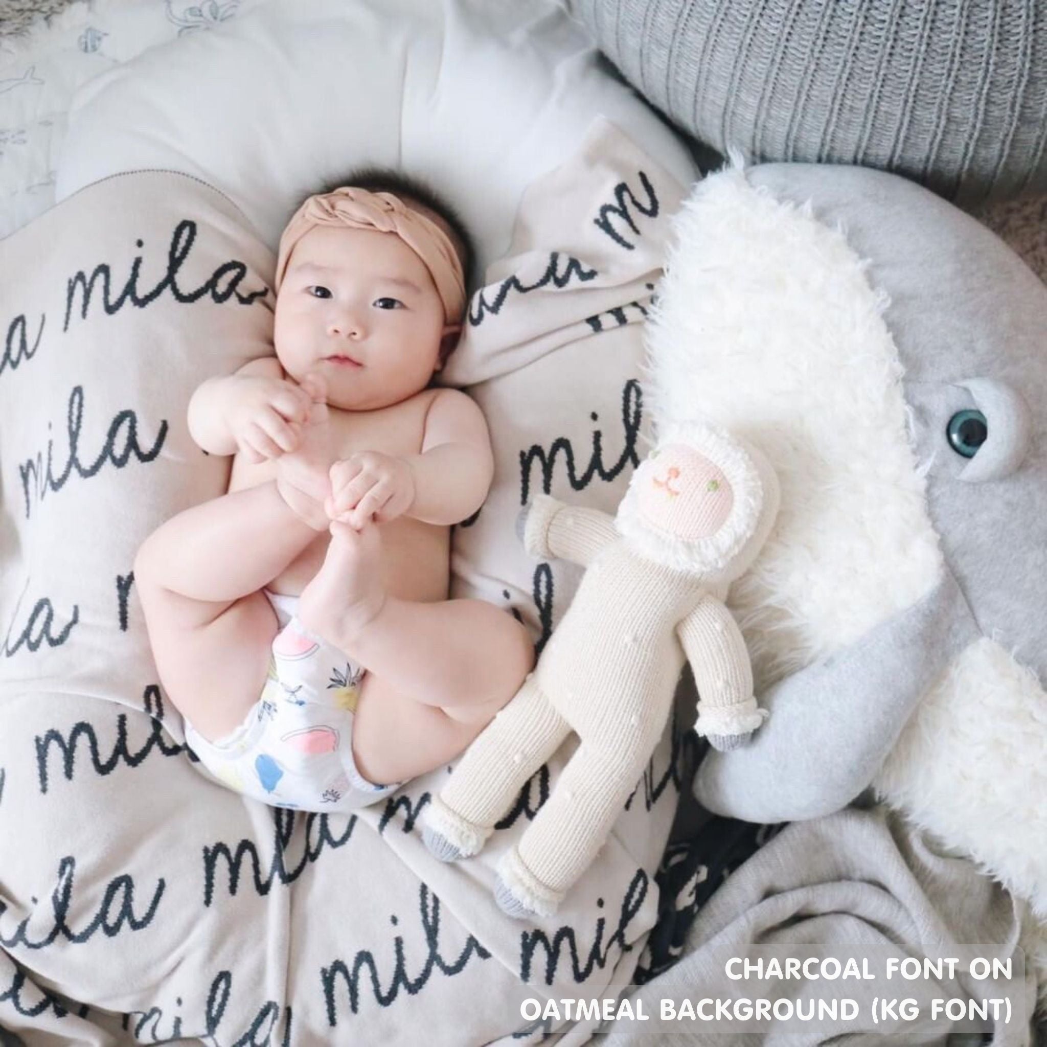 TinyBitz personalized knitted blanket in oatmeal background, customized with baby's name and made from 100% cotton.