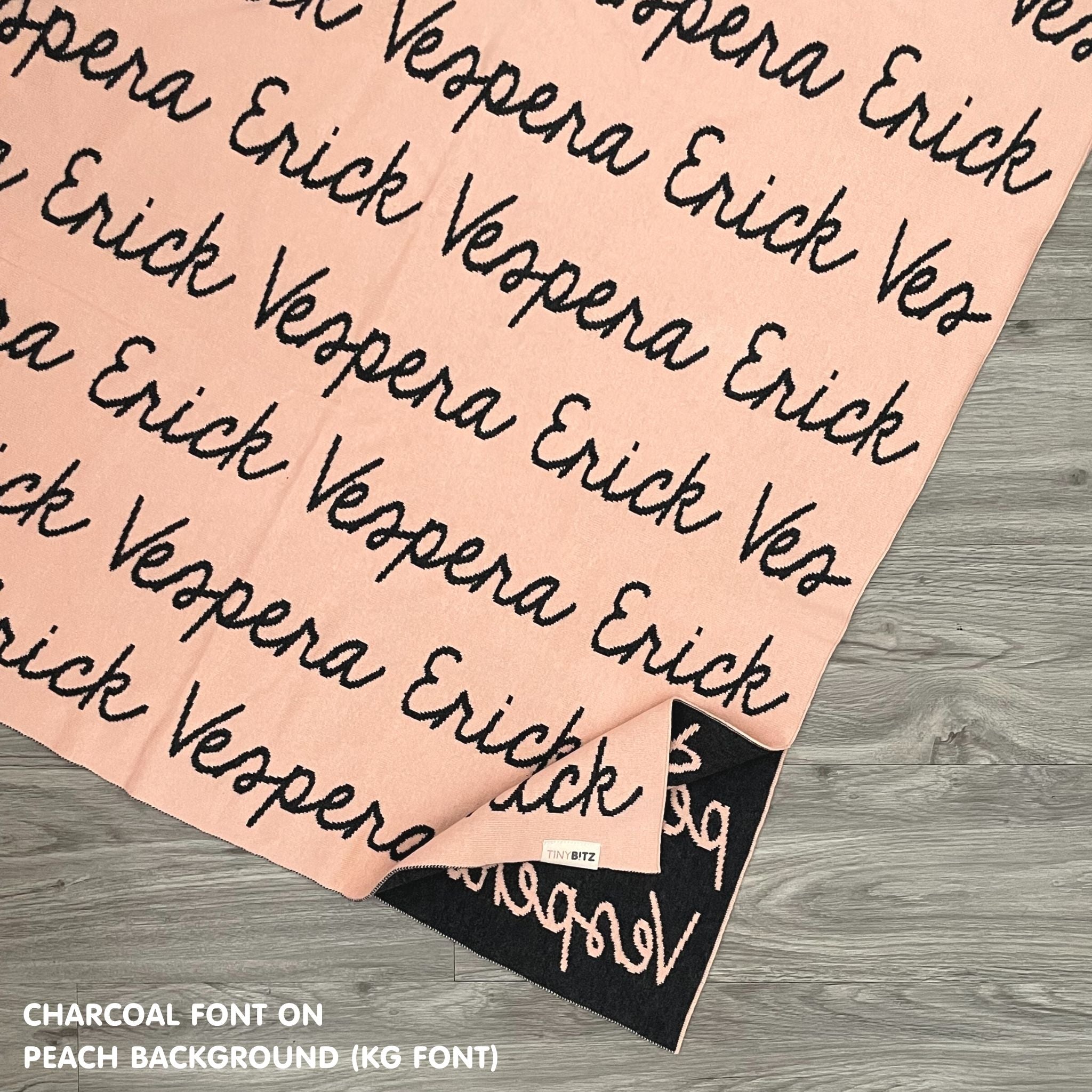 TinyBitz custom name blanket with couple's name knitted in peach and charcoal, making the perfect engagement/wedding/anniversary gift!