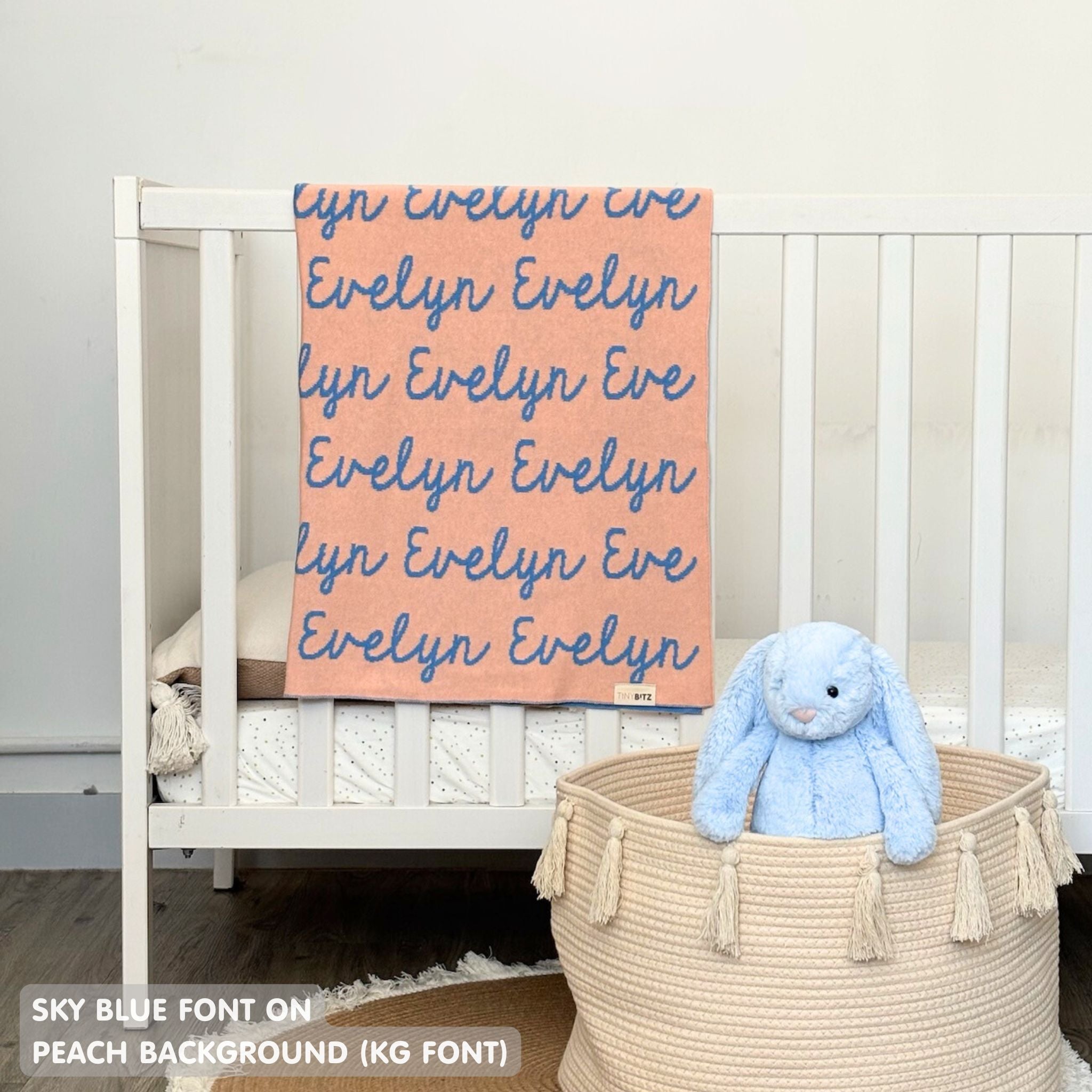 TinyBitz knitted name blanket in peach and sky blue can be used to decorate your baby's room!