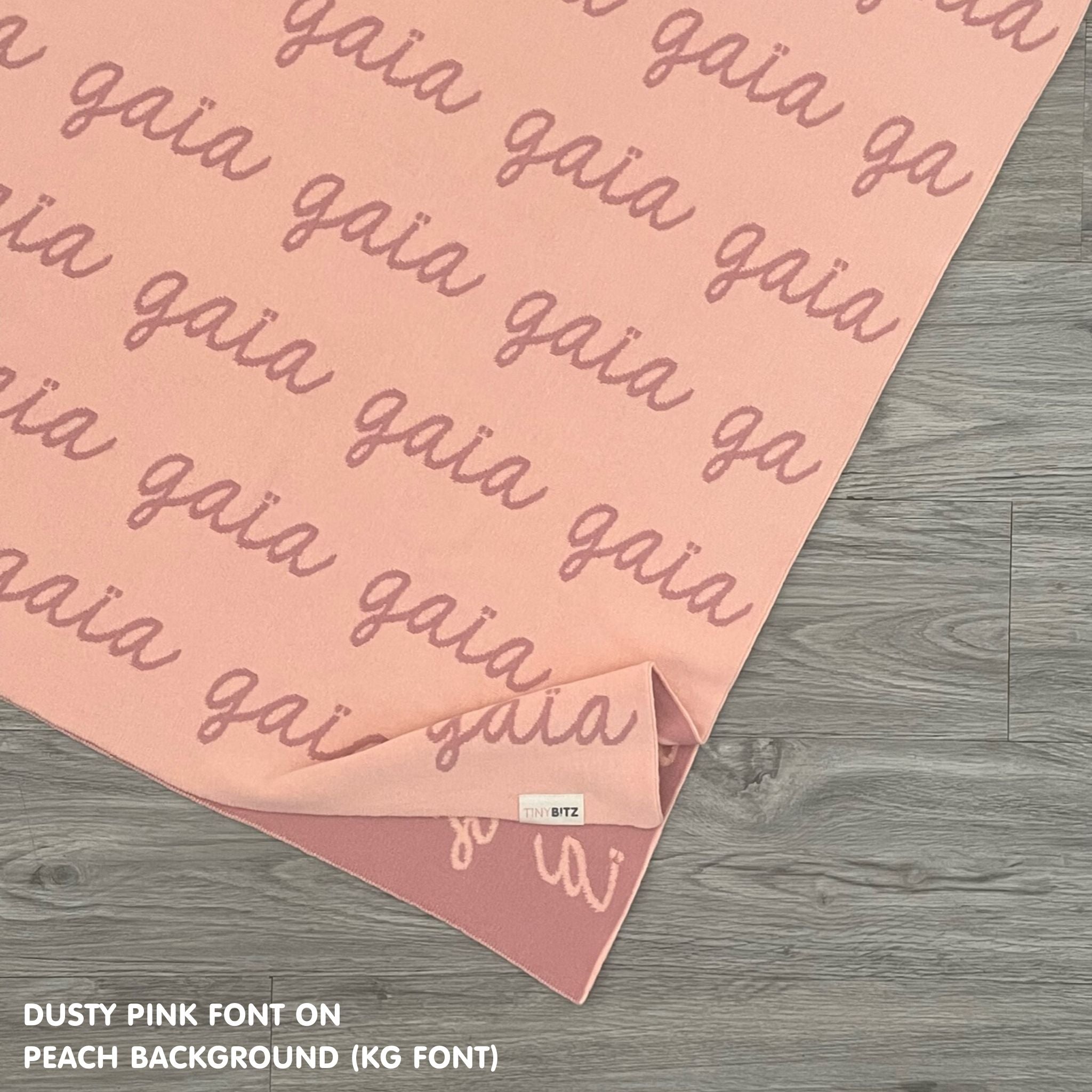 Baby blanket knitted from cotton personalized with baby's name in peach and dusty pink made by TinyBitz.