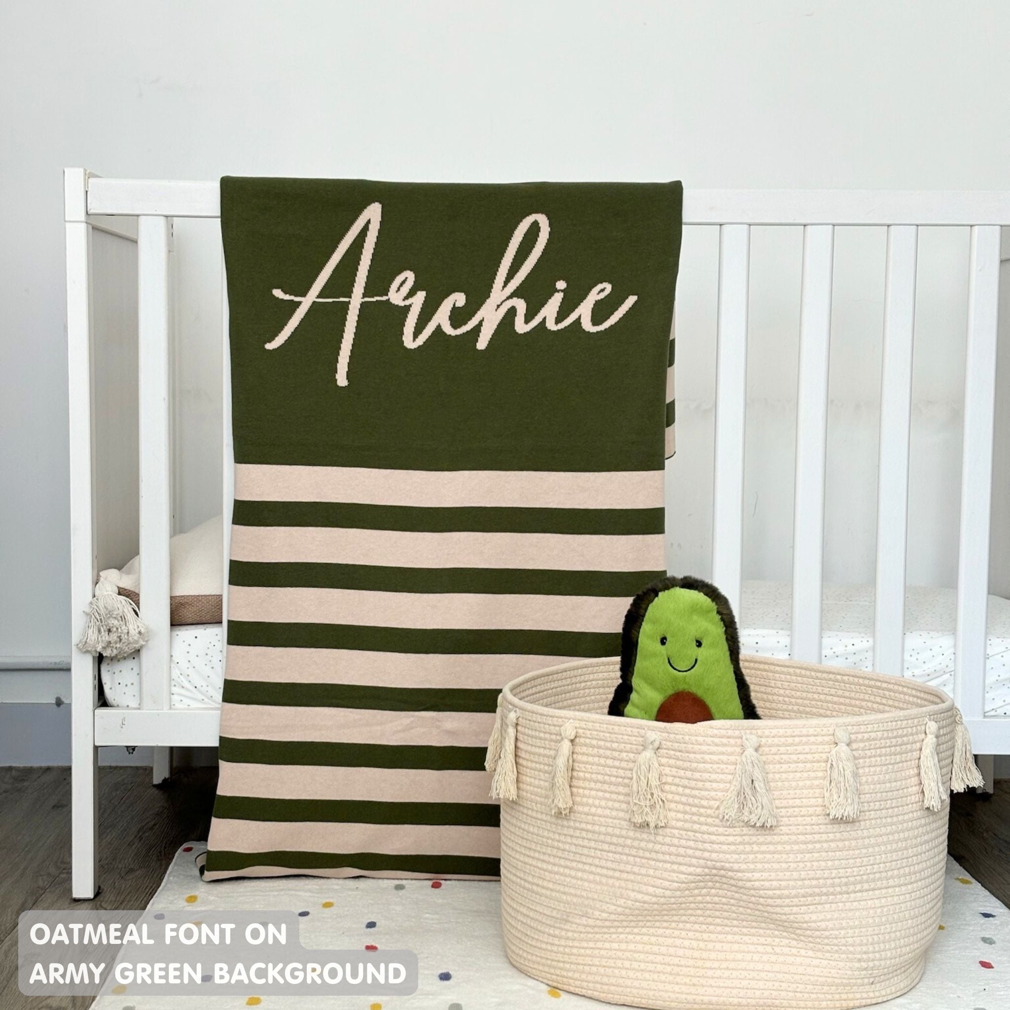 Knitted baby blanket in army green and oatmeal with a stripes pattern, customised with baby's name, made by TinyBitz.