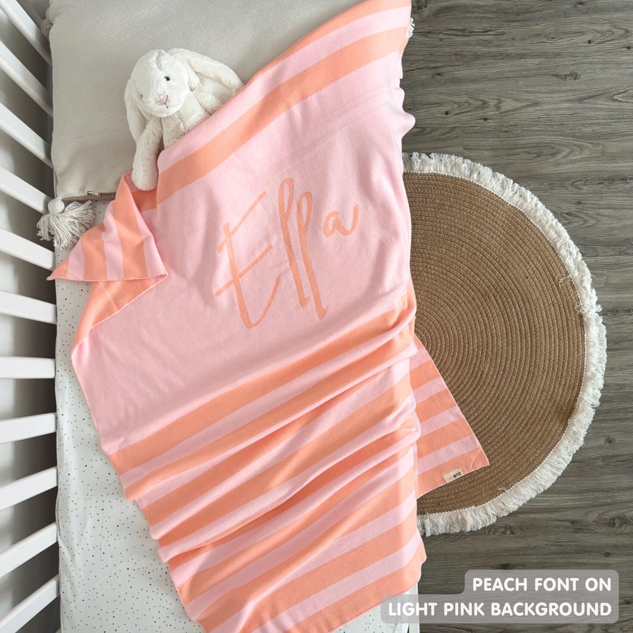 TinyBitz personalized baby name blanket, knitted in light pink and peach with a stripes pattern, perfect baby shower gift!