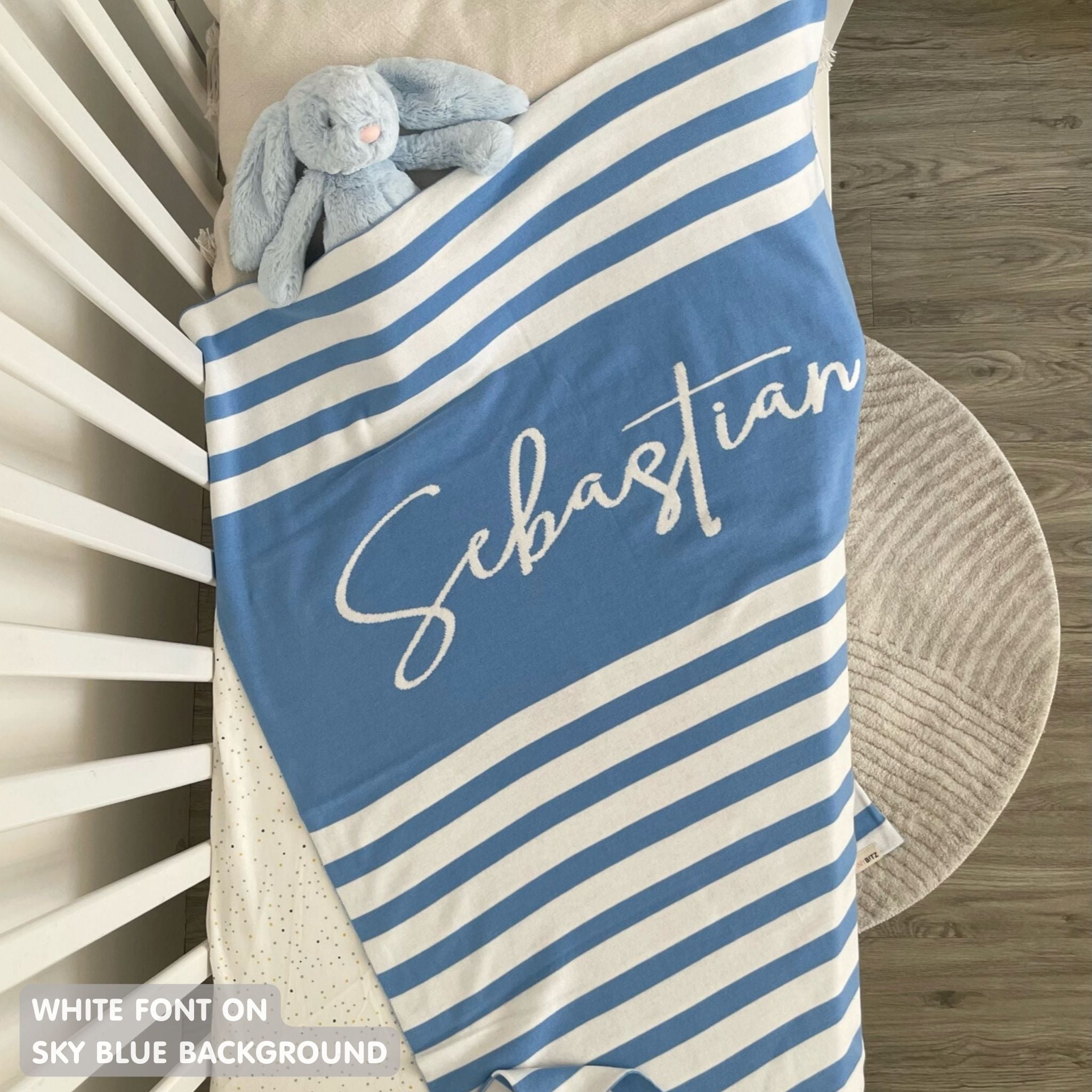 TinyBitz custom knitted blanket with baby's name on sky blue background with a stripes pattern, best gift to welcome a newborn baby.