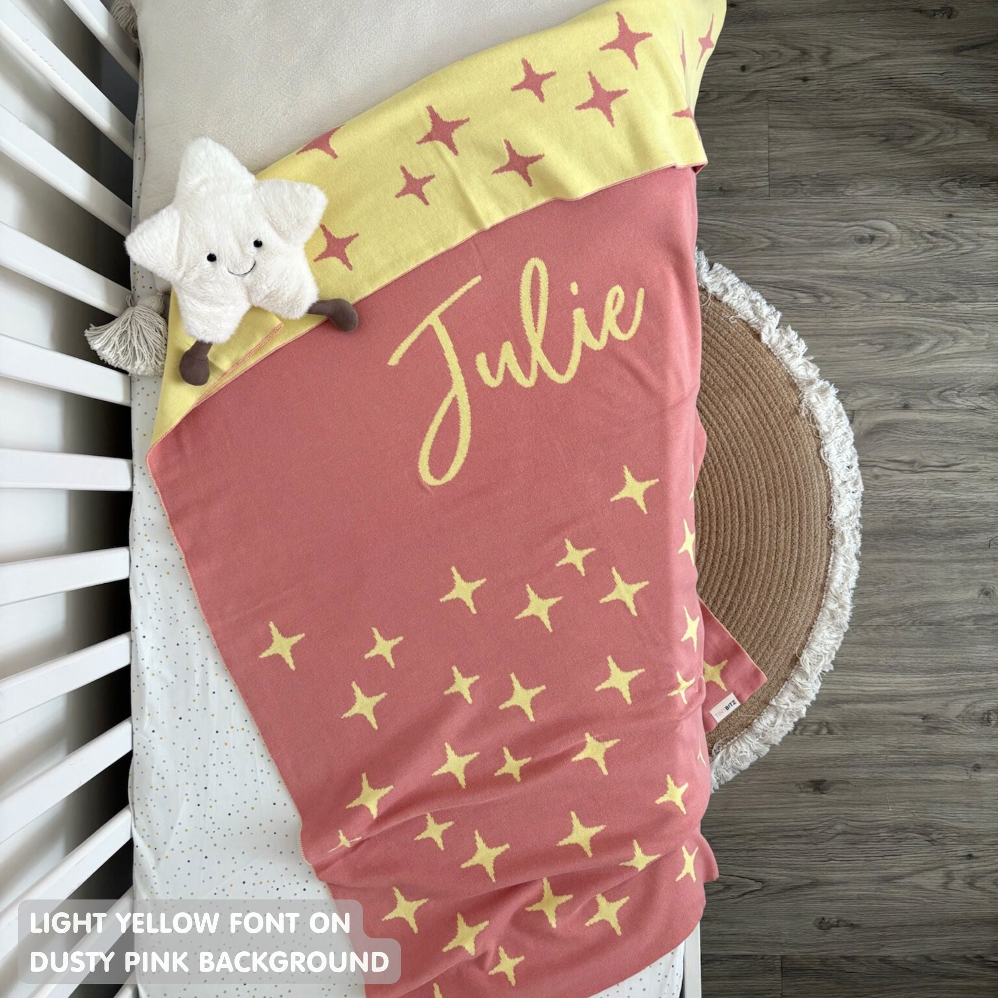 TinyBitz knitted name blanket in dusty pink and light yellow with a twinkles pattern, a lovely touch to decorate your baby's room!