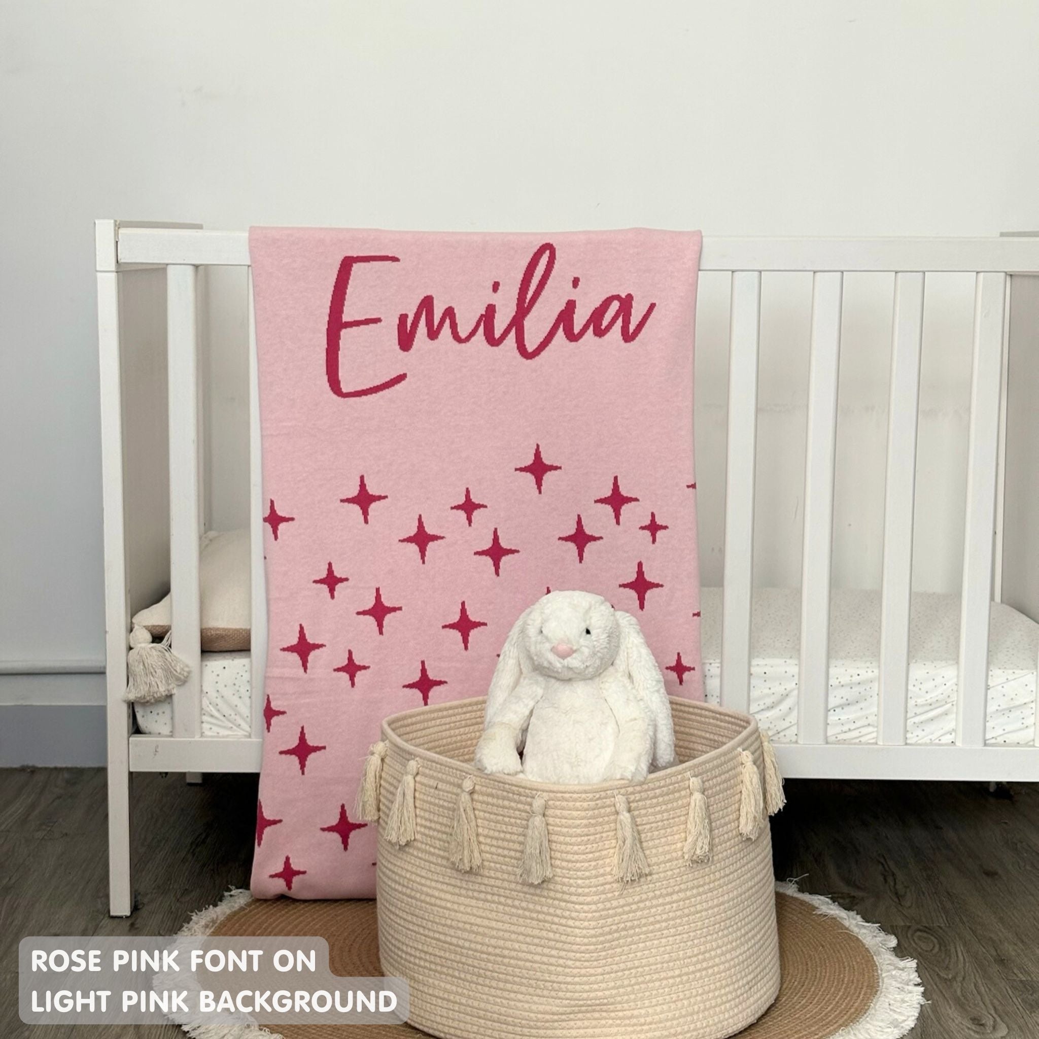 Knitted baby blanket in light pink and rose pink with a twinkles pattern, customised with baby's name, made by TinyBitz.