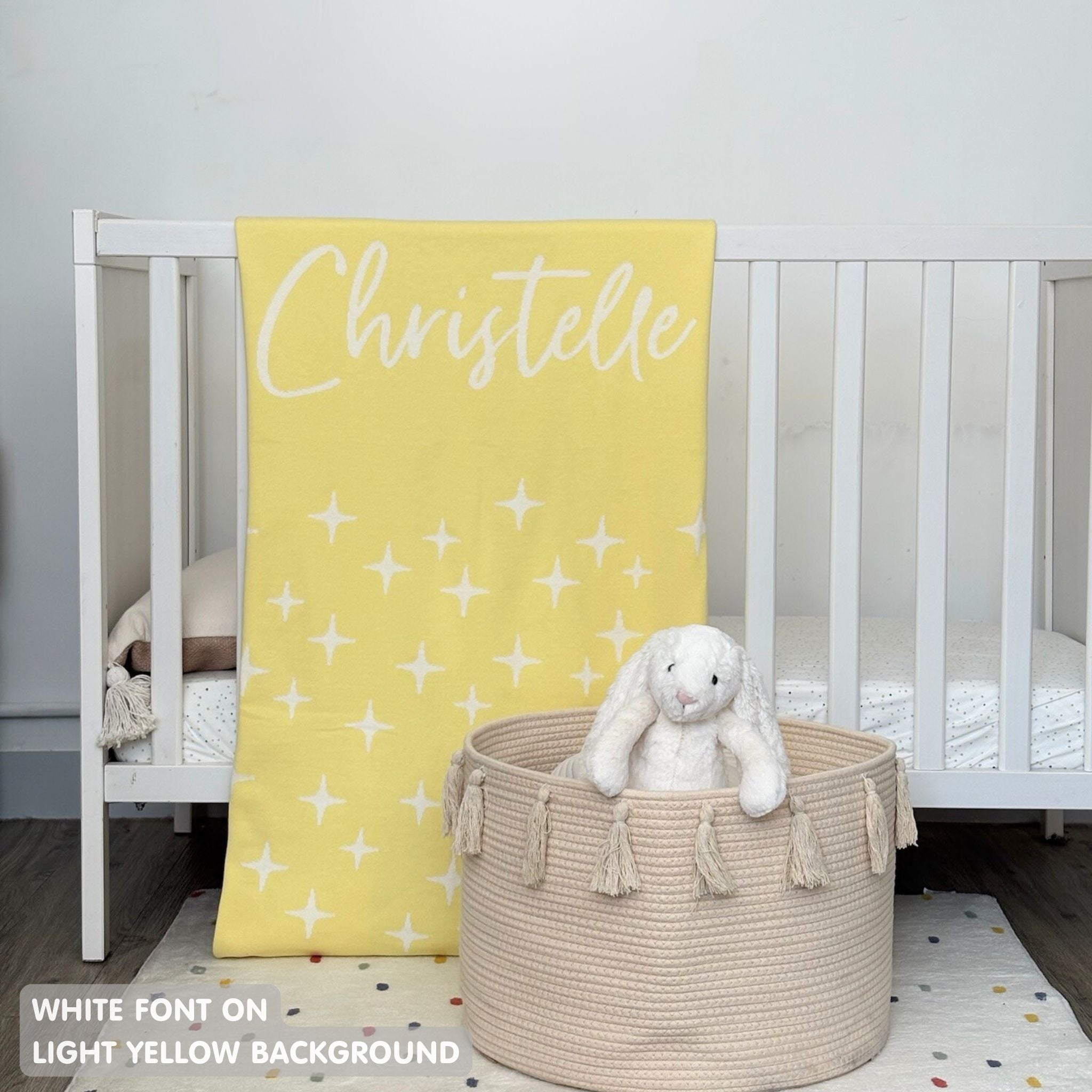 TinyBitz custom knitted blanket with baby's name on light yellow background with a twinkles pattern, best gift to welcome a newborn baby.