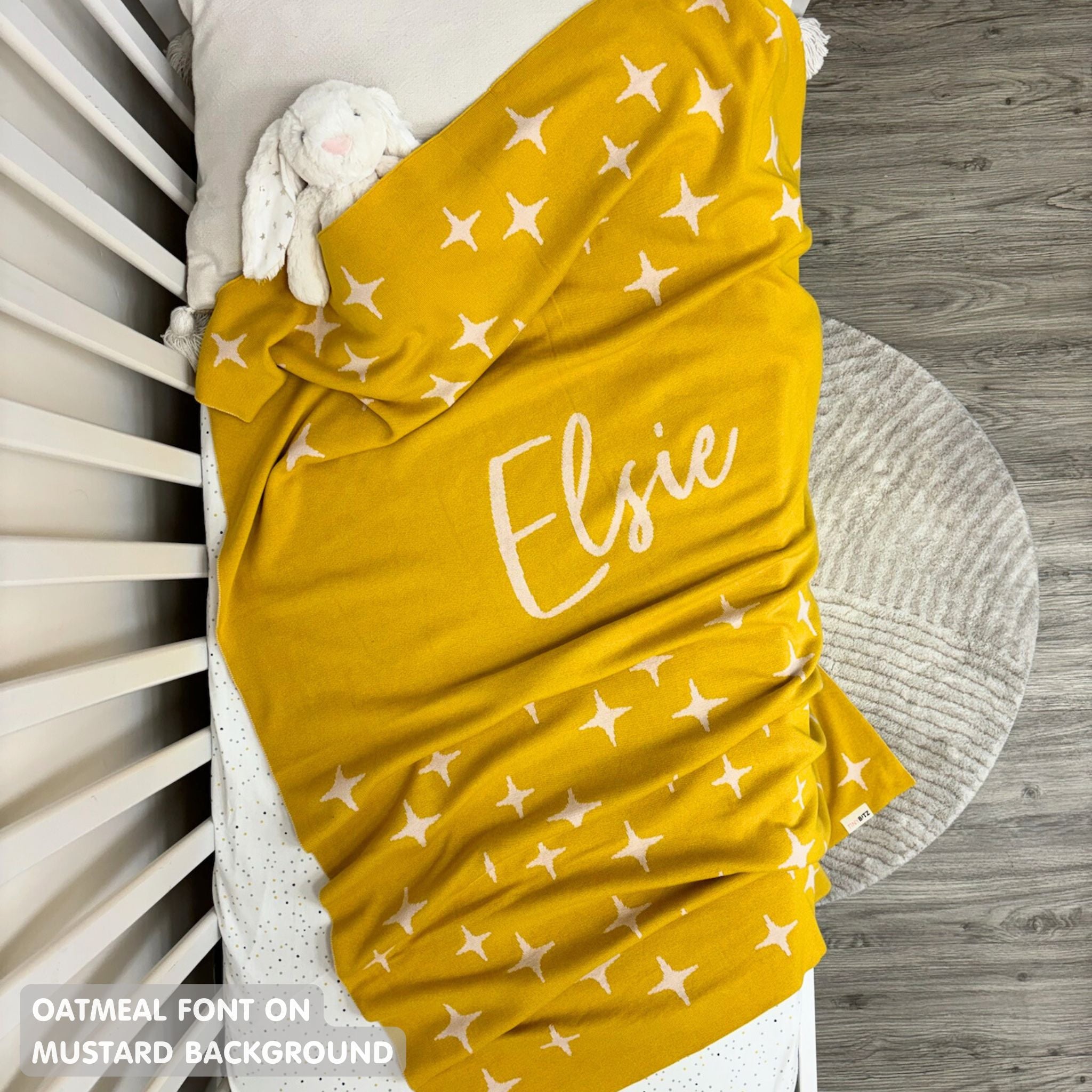 TinyBitz personalized name blanket in mustard and oatmeal with a twinkles pattern, perfect gift for newborn babies and kids.