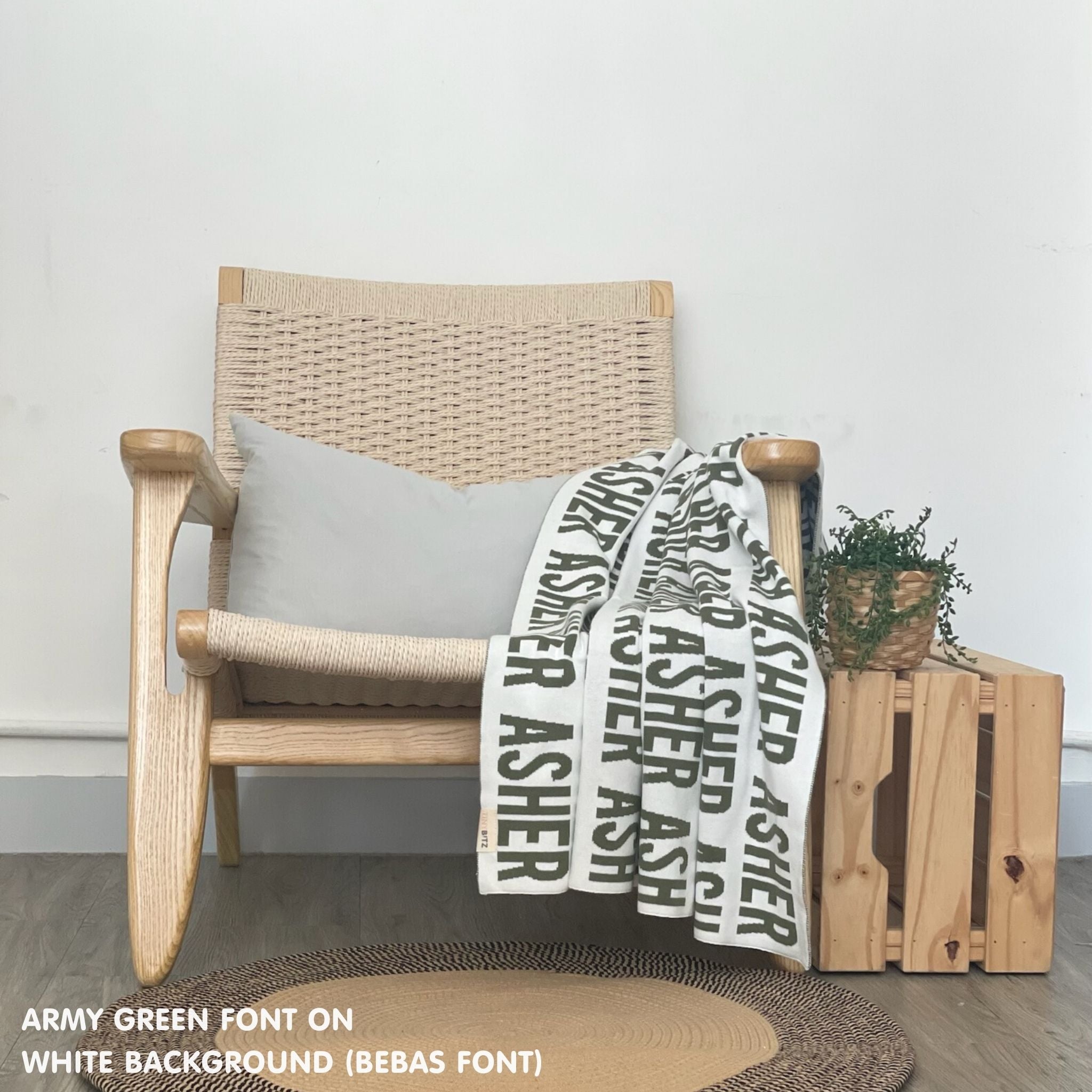 Customisable blanket with adult's name knitted in white and army green, personalized by TinyBitz.