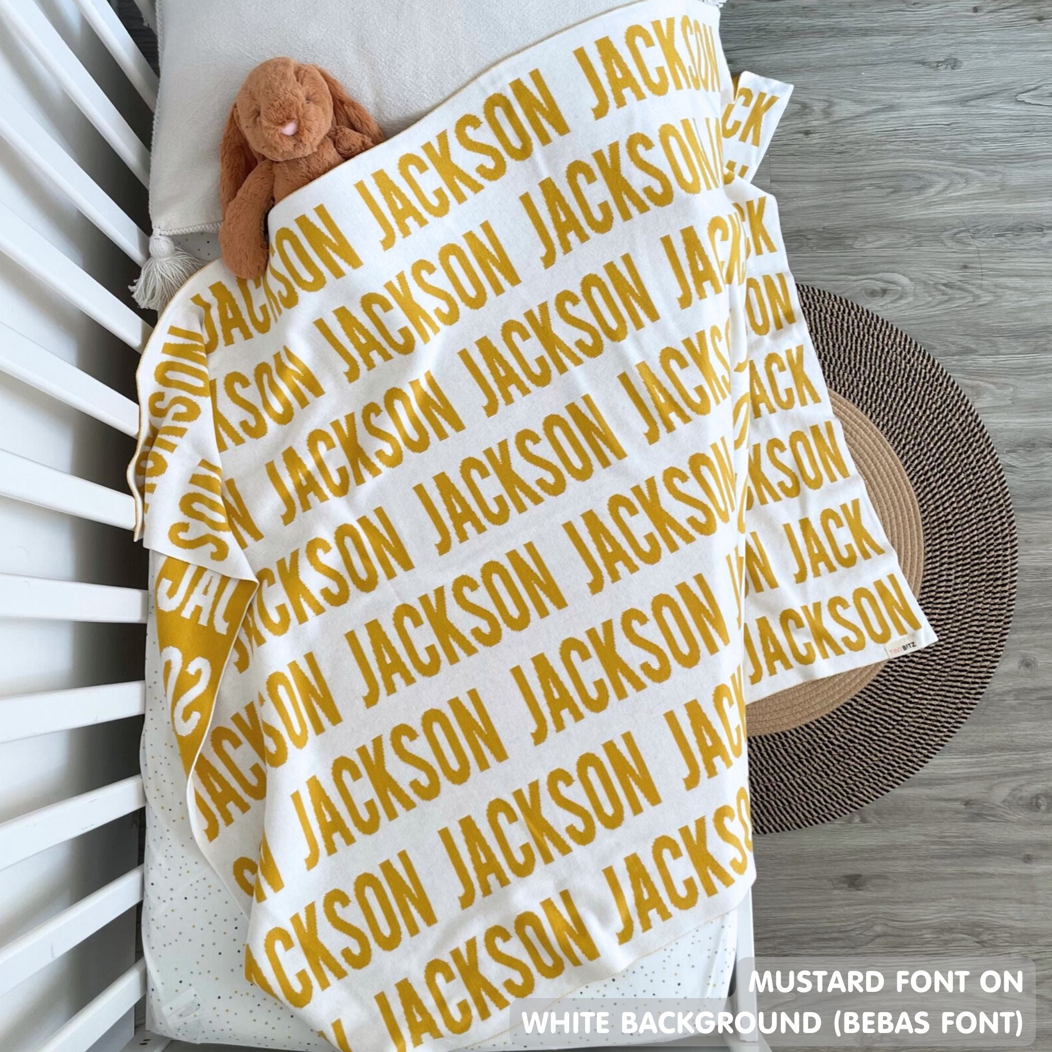 TinyBitz knitted name blanket in white and mustard can be used to decorate your baby's room!