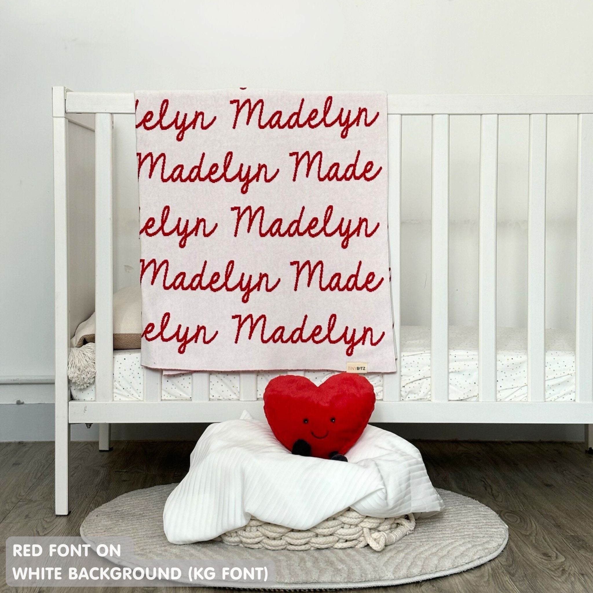 Knitted baby blanket in white and red, customised with baby's name, made by TinyBitz.