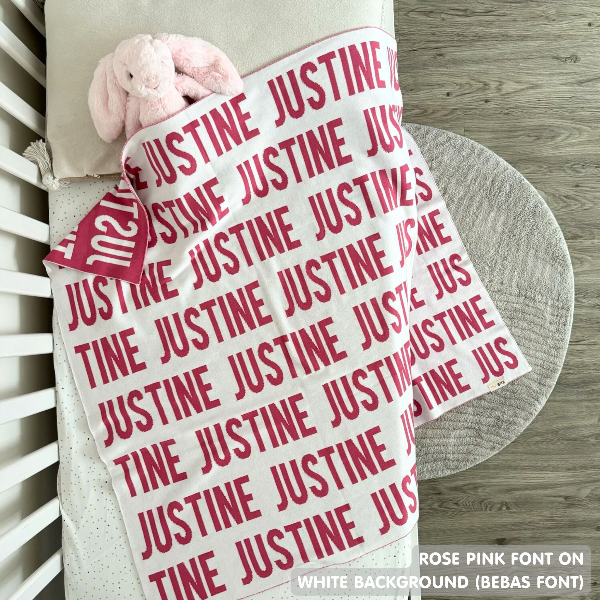 Baby blanket knitted from cotton personalized with baby's name in white and rose pink, made by TinyBitz.