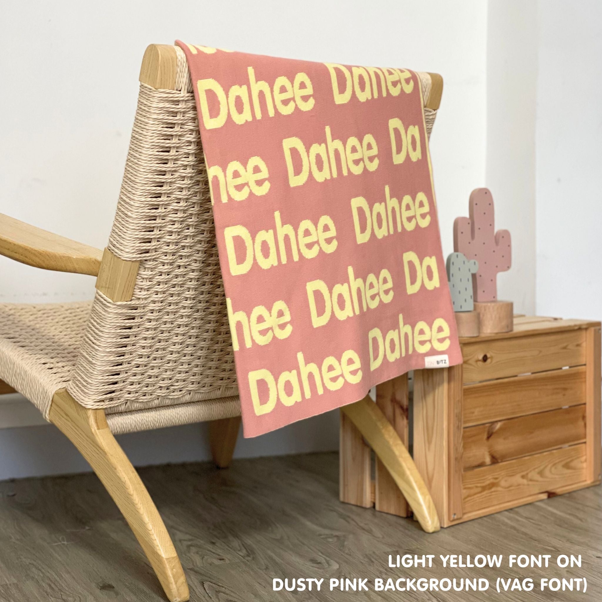 TinyBitz knitted cotton blanket in dusty pink and light yellow, personalized with your kid’s name.